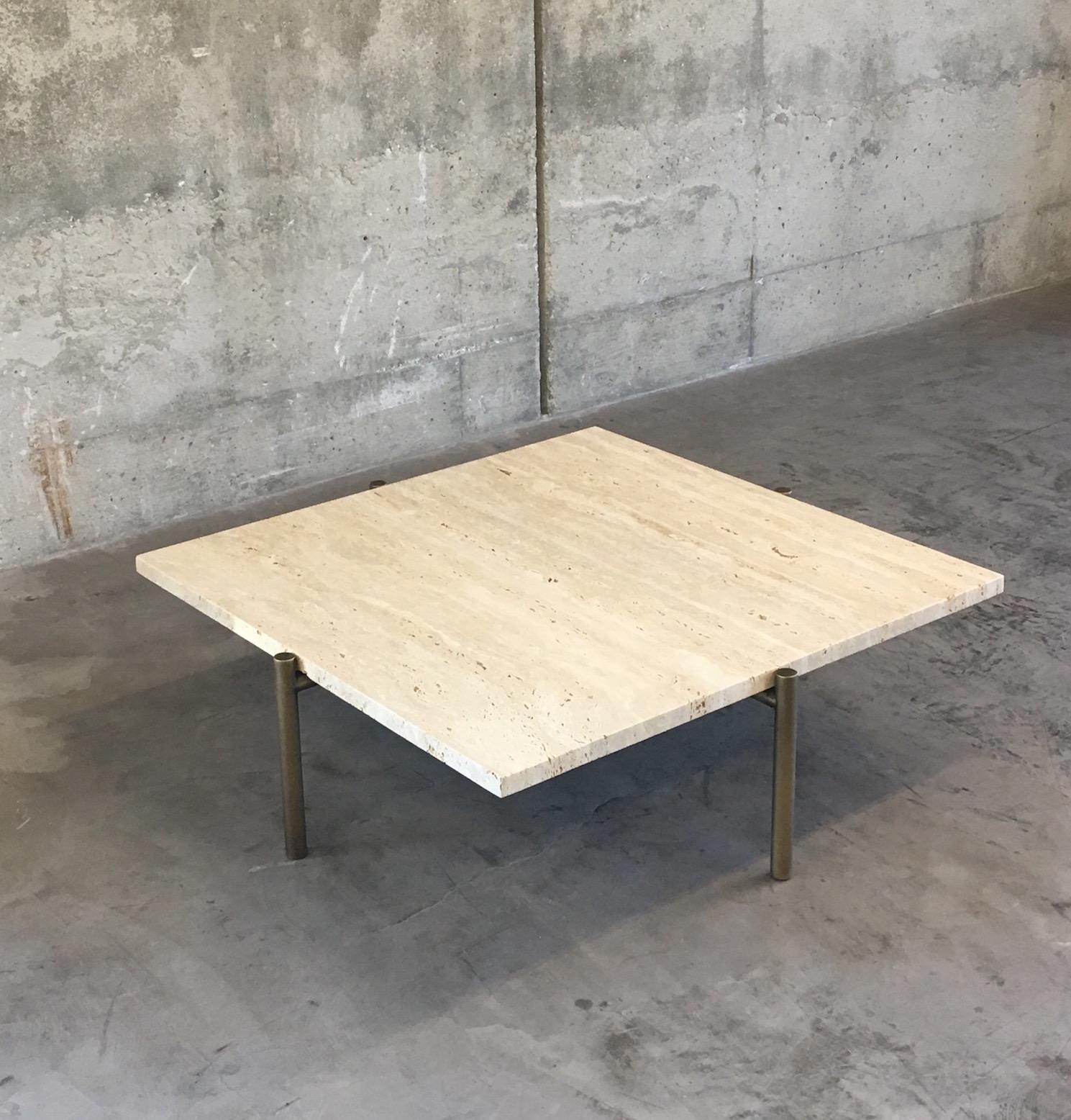 Ten10 Tivoli coffee table with 4 legs and a square travertine top. The base is stainless steel tube plated in brass with a burnished finish. The top is 3cm thick vein cut unfilled honed Roman travertine. The travertine is naturally porous and the