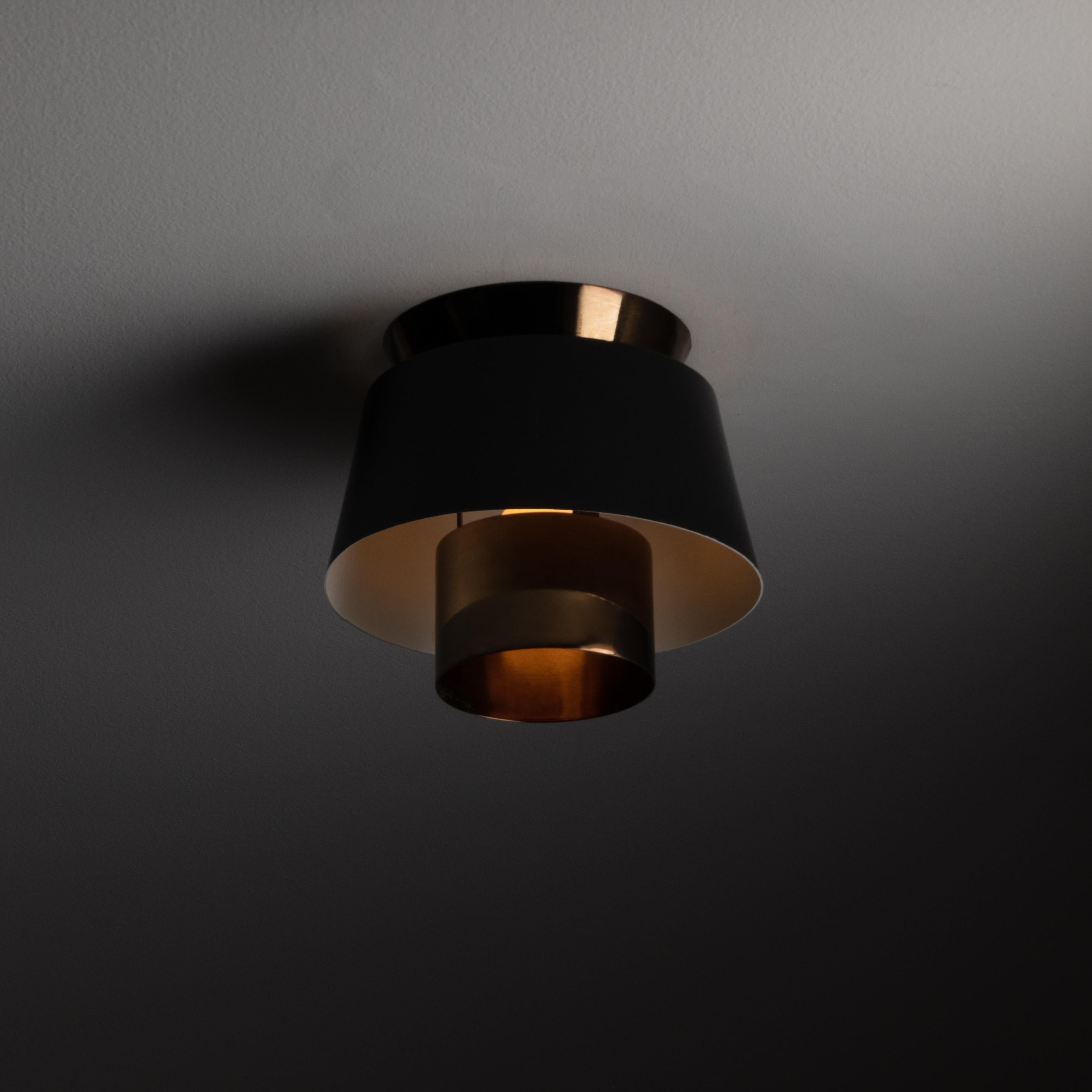 Tivoli flush mounts by Jørn Utzon for Nordisk Solar. Designed and manufactured in, circa 1940s. Black lacquered finish on exterior shell of shade, with internal brass features. Brass has been polished and has very nice patination since years