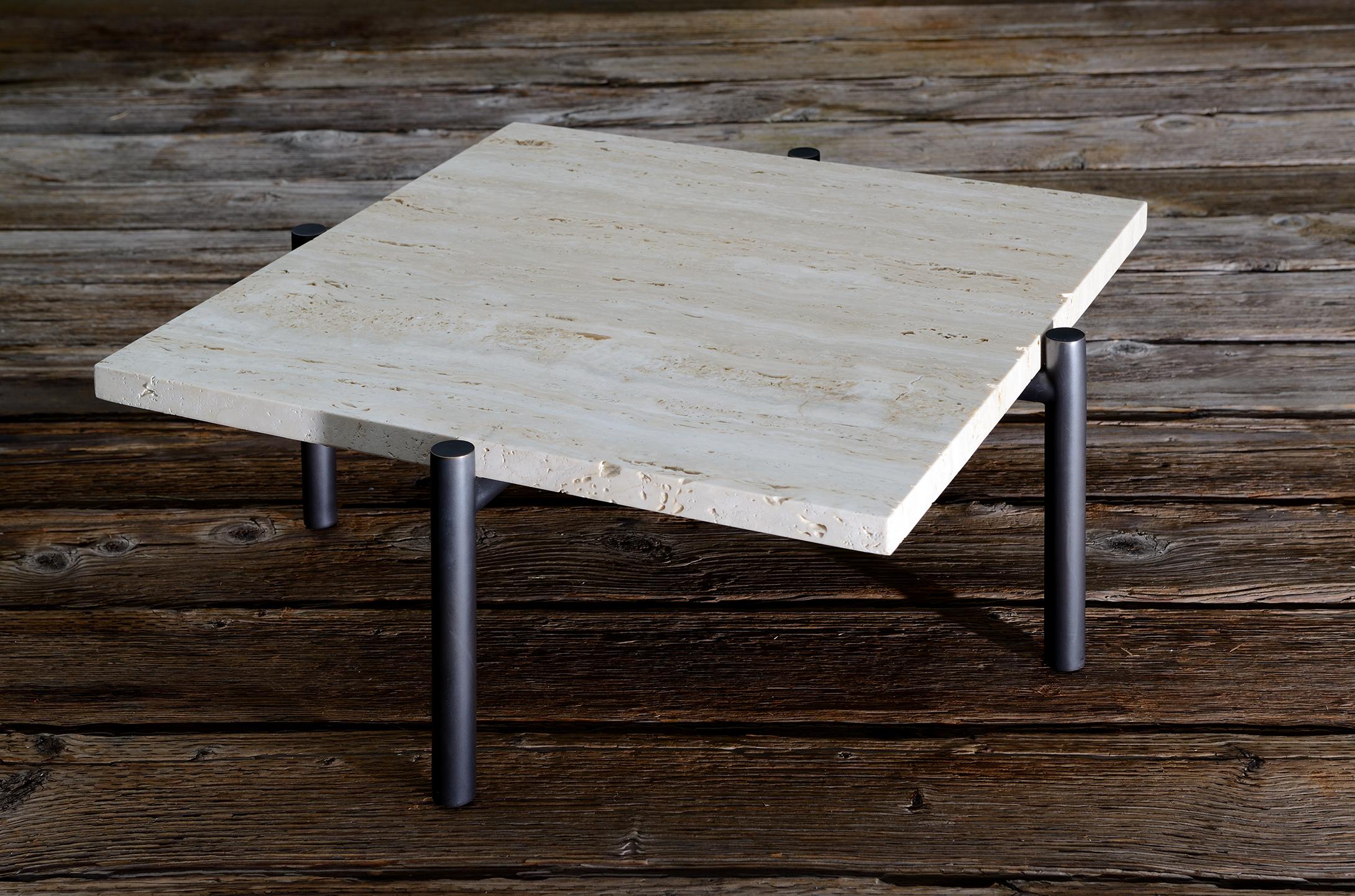 Ten10 Tivoli side table with 4 legs. The base is stainless steel tube plated in oil rubbed bronze (or it can also be burnished brass). The top is 3cm thick vein cut unfilled honed travertine. The stone is unfilled to show its natural qualities. The