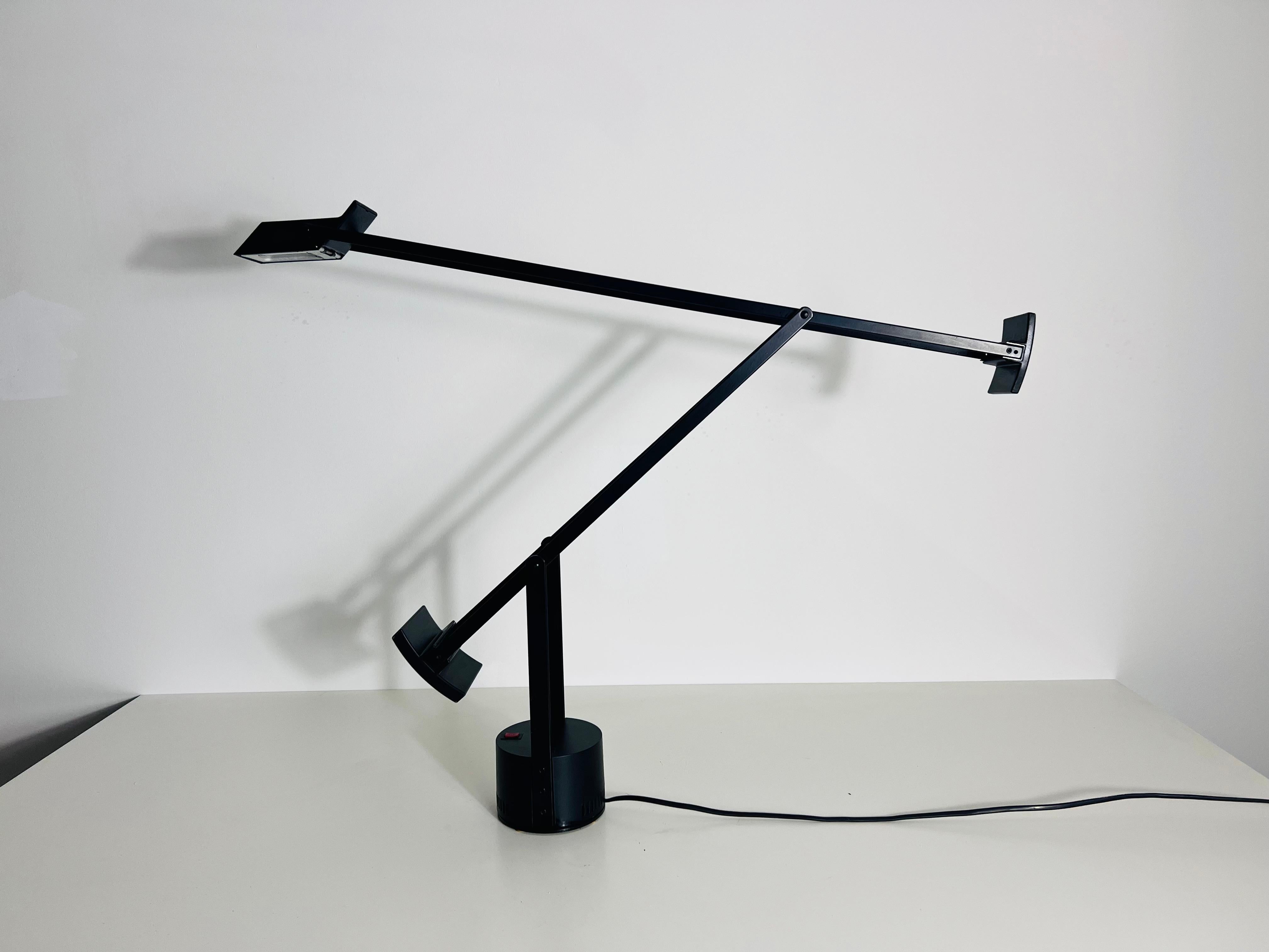 This is a highly sought-after adjustable table lamp, designed by the renowned Richard Sapper for the prestigious Italian design brand Artemide. Originally conceived and manufactured in Italy in 1972, this lamp stands as a testament to Sapper’s