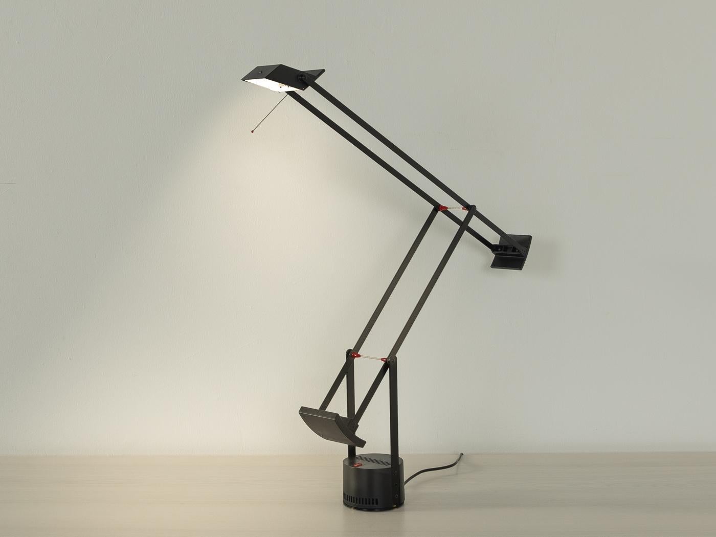 TIZIO table lamp by Artemide. High-quality stainless steel frame in black, that can be raised and lowered, with a rotatable lamp head.

Quality Features:

    very good workmanship
    high-quality materials
    Made in Italy. Design: R.Sapper,