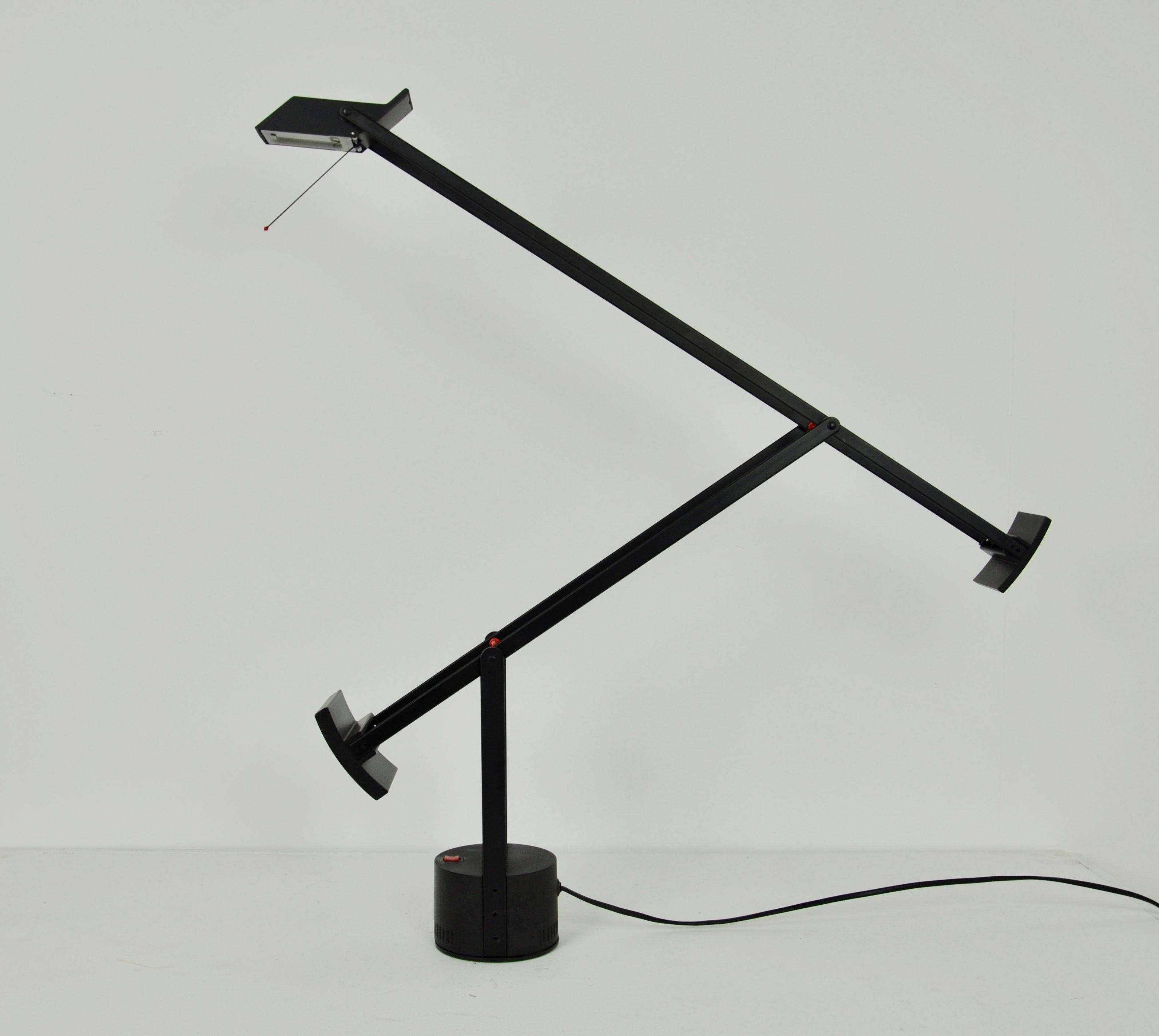 Black articulated lamp, wear and tear due to time and the age of the lamp.