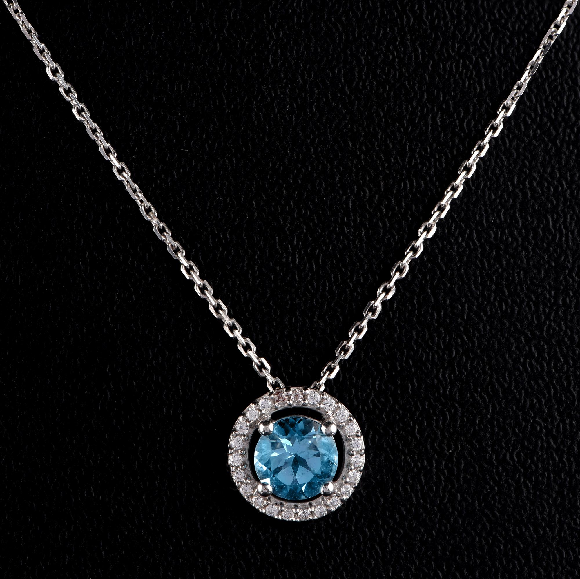 Elegant pendant necklace studded with 23 brilliant-cut diamonds and 1 Swiss blue topaz gemstone in prong setting and designed in 18-karat white gold. The diamonds are graded H-I Color, I2 Clarity

The pendant comes along with an 18 inch cable chain.