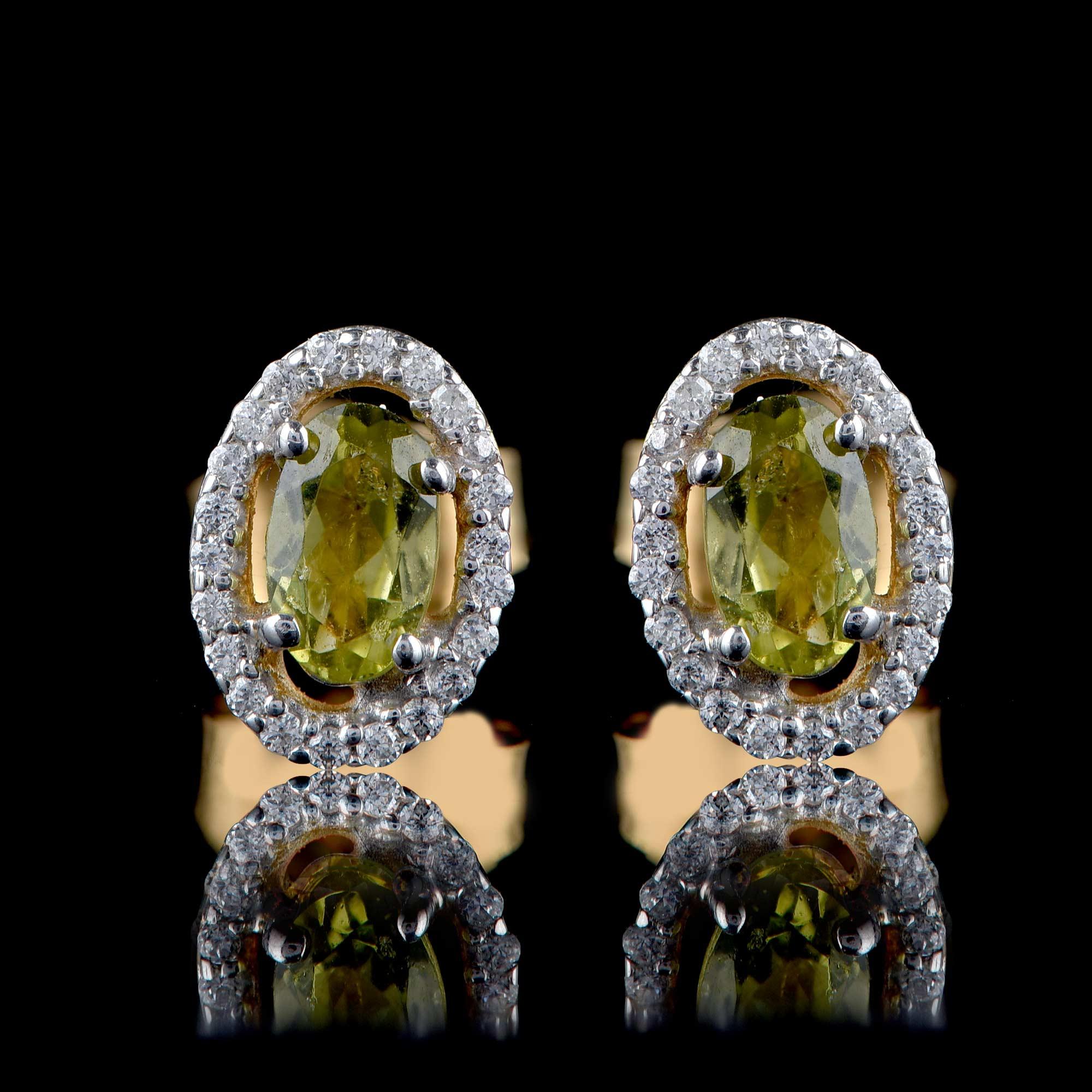 Hand-crafted elegantly in 18-karat yellow gold and embellished beautifully with 44 brilliant diamonds and 2 oval shaped peridot in prong setting. The diamonds are graded H-I Color, I2 Clarity.