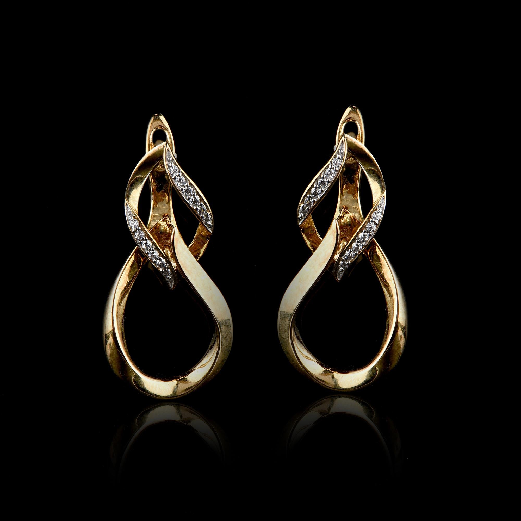 Smart and unique, this diamond hoop earrings are certain to be notice. Made by our skillful craftsmen in 14 karat yellow gold and accentuated with 24 round brilliant diamond in prong setting, which shines in H-I color I2 clarity. Polished to a