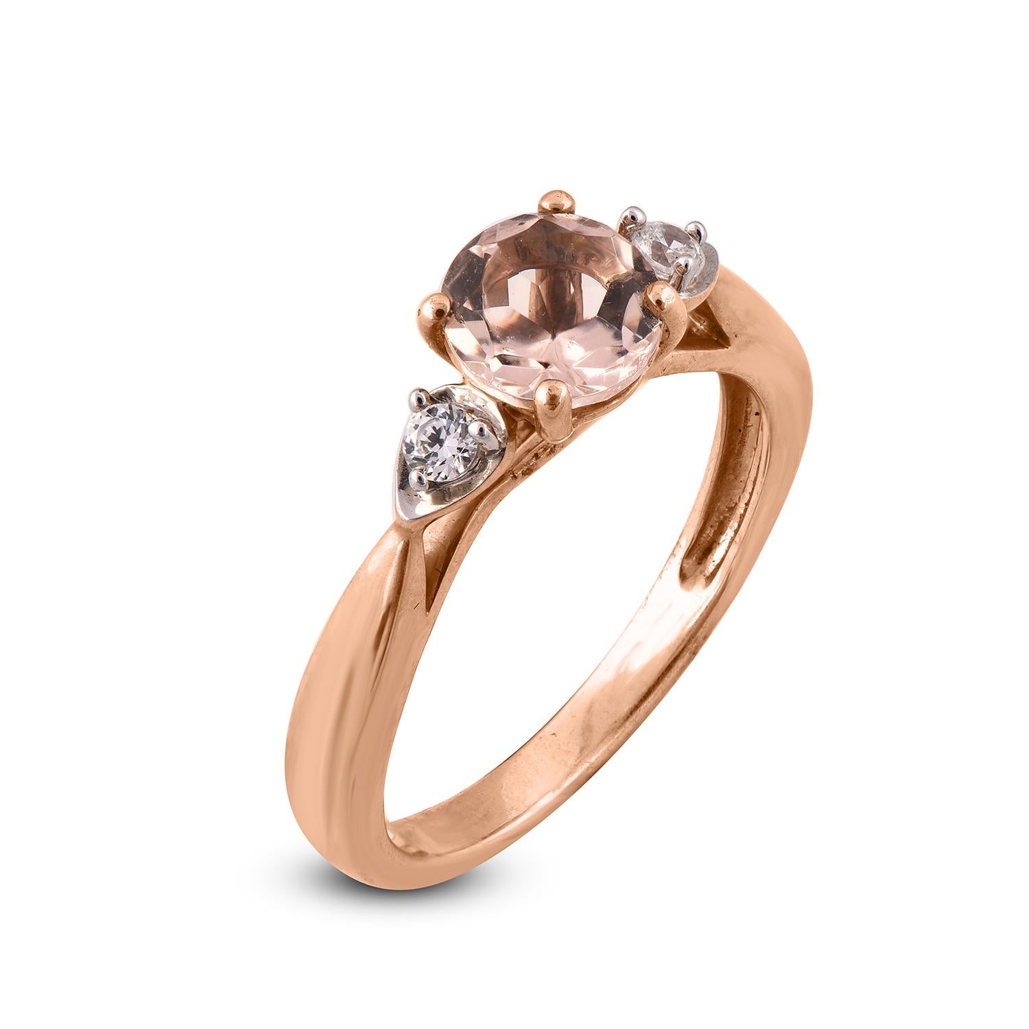 This diamond ring sparkles with 1 morganite gemstone with 2 white diamonds and is fashioned in 14 karat rose gold. The diamonds are elegantly set in prong  setting. Diamonds are graded H-I Color, I2 Clarity.
