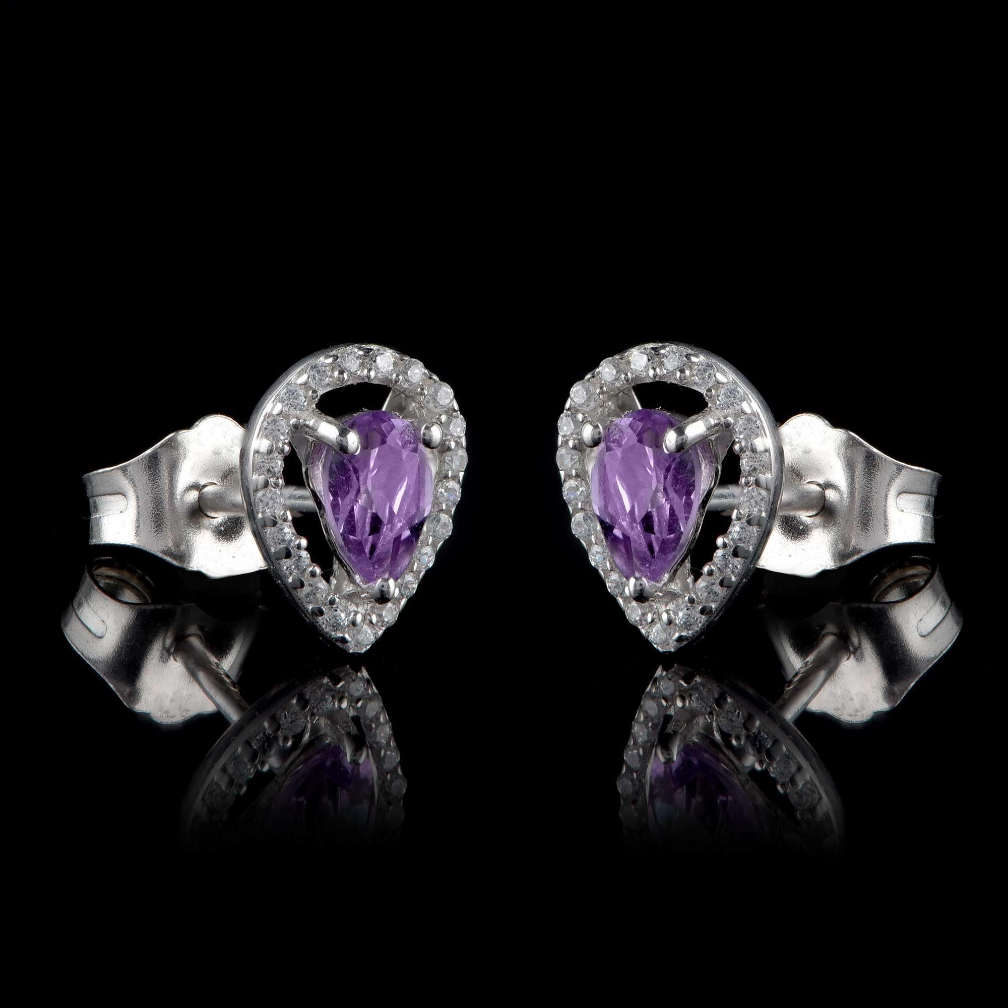 These dainty diamond and gemstone earrings are crafted in 18-karat white gold. The stud earrings are embellished with 42 brilliant cut diamonds and 2 amethysts in prong setting. The diamonds are graded H-I Color, I2 Clarity. Locks comfortably with