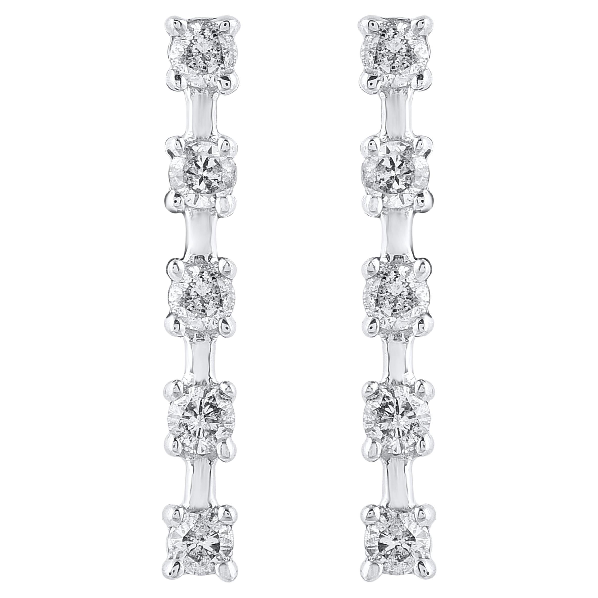 Timeless and elegant, these diamond drop earrings go from day to night with ease. This earring is beautifully designed and studded with 10 brilliant cut natural diamond set in prong setting. The total diamond weight is 0.15 carat. The diamonds are