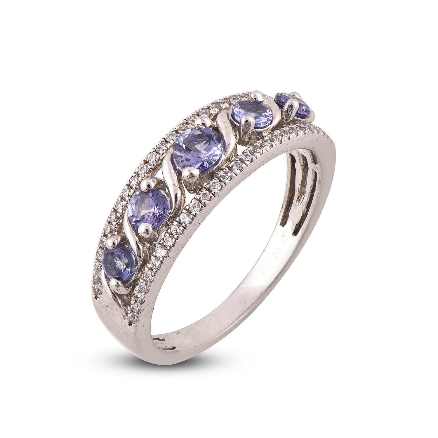 If your girl wants a classic engagement ring with a unique twist, this engagement ring with diamond accents might be the one! Handcrafted in 14 karat white gold with tanzanite and diamonds. Its features with 54 round white diamond and 5 round cut