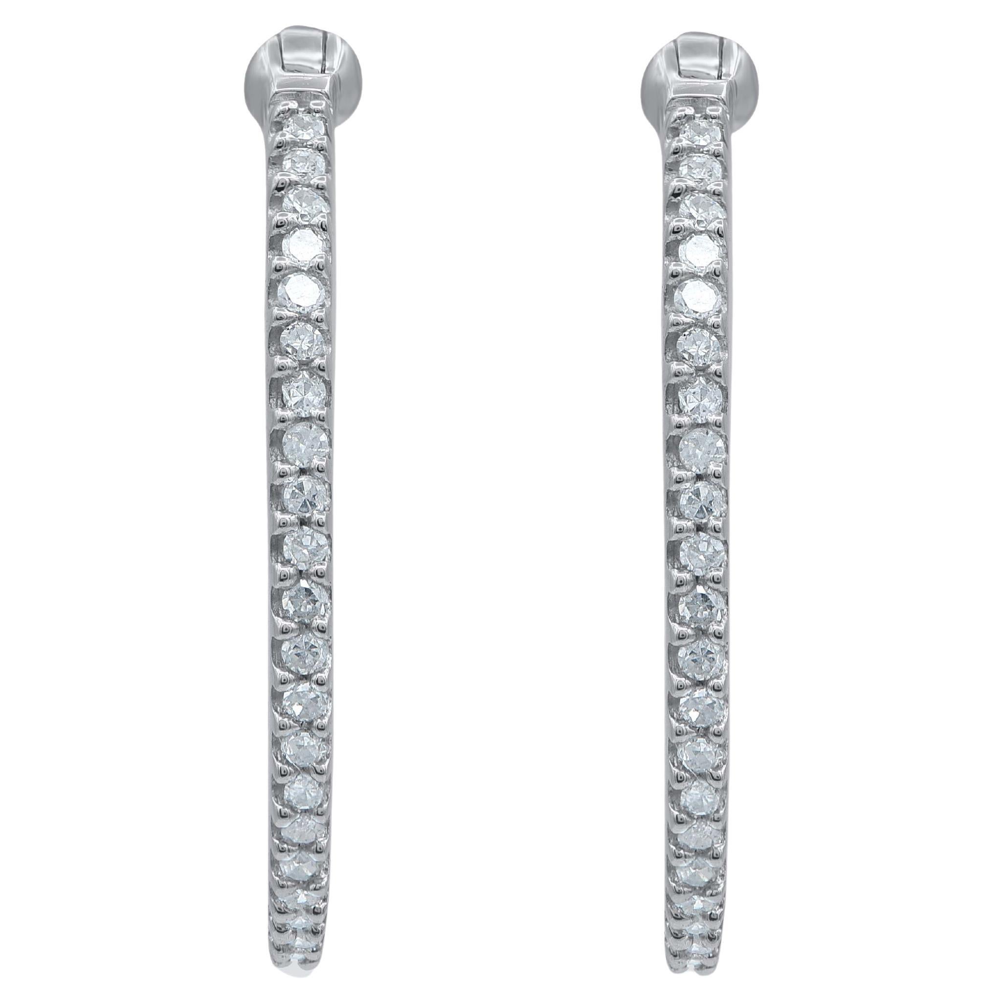 A style must-have, these diamond hoop earrings dress up any look. Crafted in 14 karat white gold with 82 single cut round diamond in prong setting. These earring secure with hinged backs. Total diamond weight is 0.25 carat. The white diamonds are