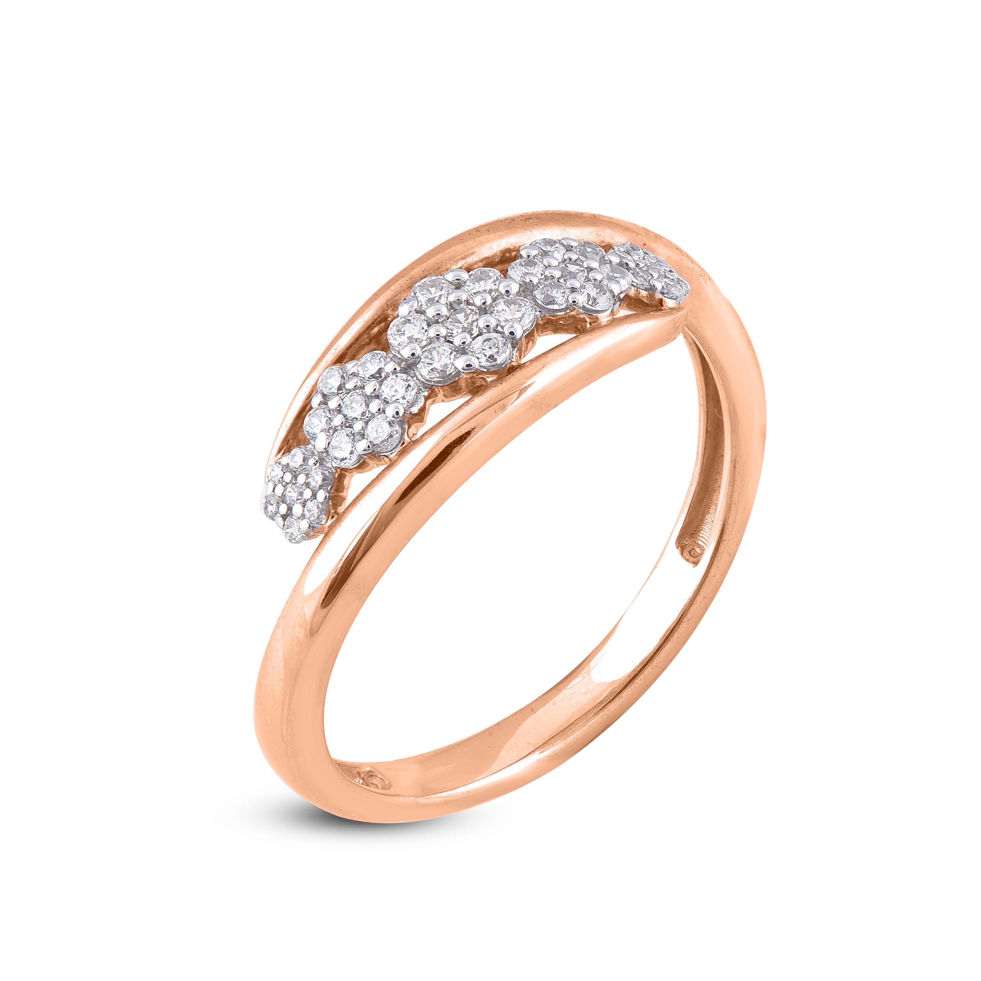 Stunning and classic, this diamond cluster crossover ring is crafted in 14K rose gold. This crossover wedding band ring is studded with sparkling 35 round white diamonds in secured prong setting. The diamonds are natural, not-treated and