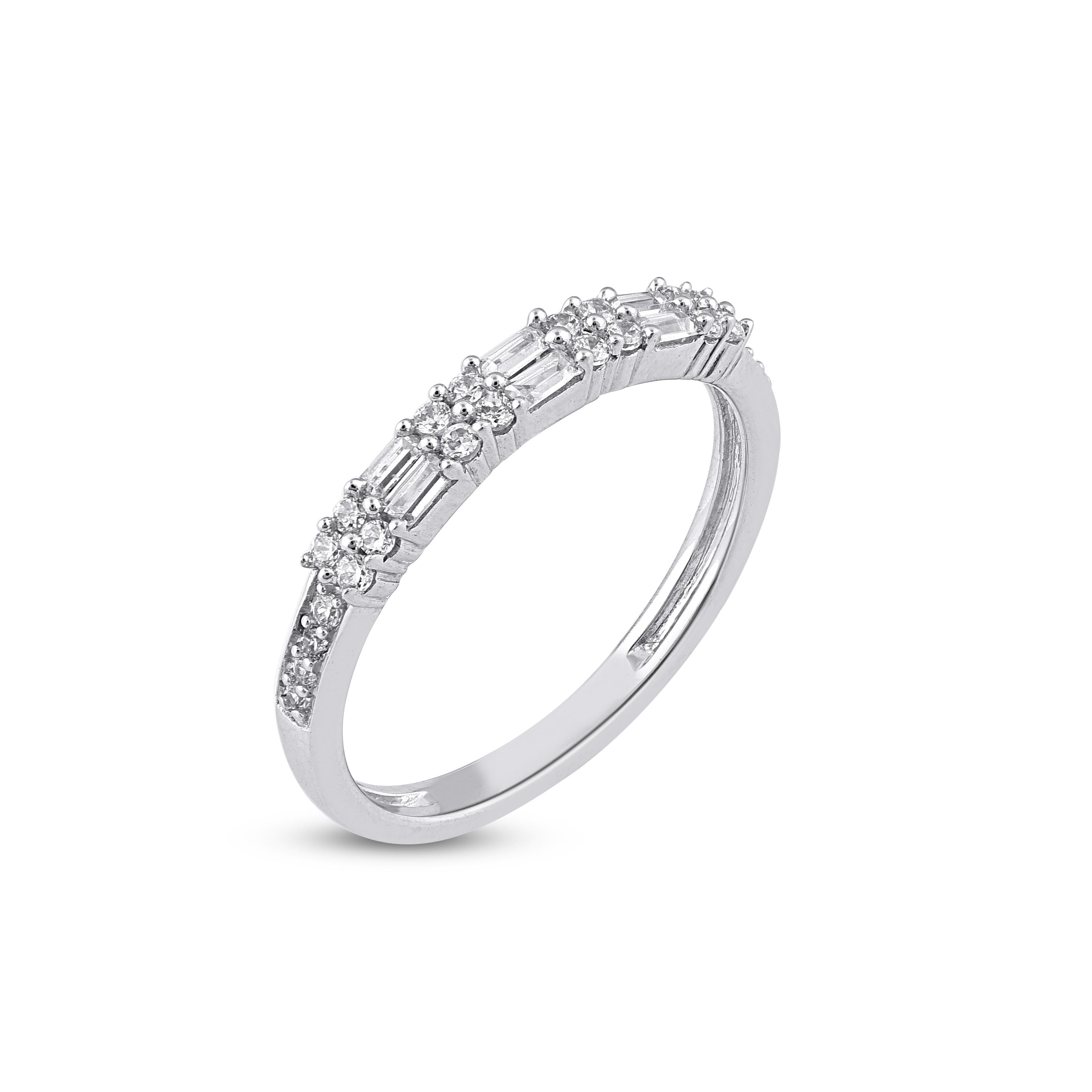 Semplicemente stupefacente, questa fede con diamante brilla con l'emozione del momento. L'anello è realizzato in oro bianco a 14 carati e presenta 24 diamanti tondi taglio brillante e 6 diamanti bianchi taglio baguette, con incastonatura Prong e