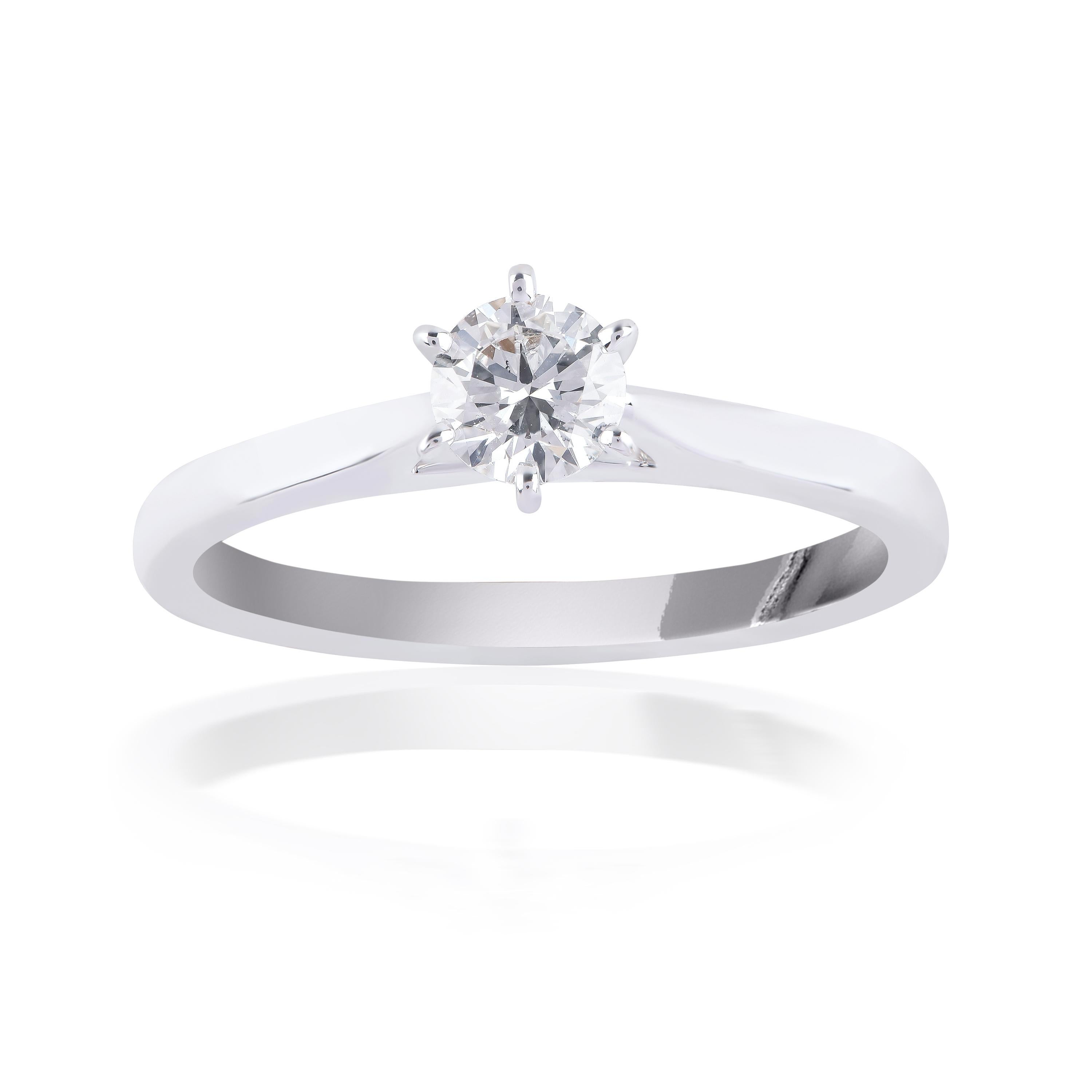 This classic solitaire ring is studded with 1 brilliant cut diamond and is designed in 18-karat white gold. The diamonds are graded G-H Color, VS Clarity.
