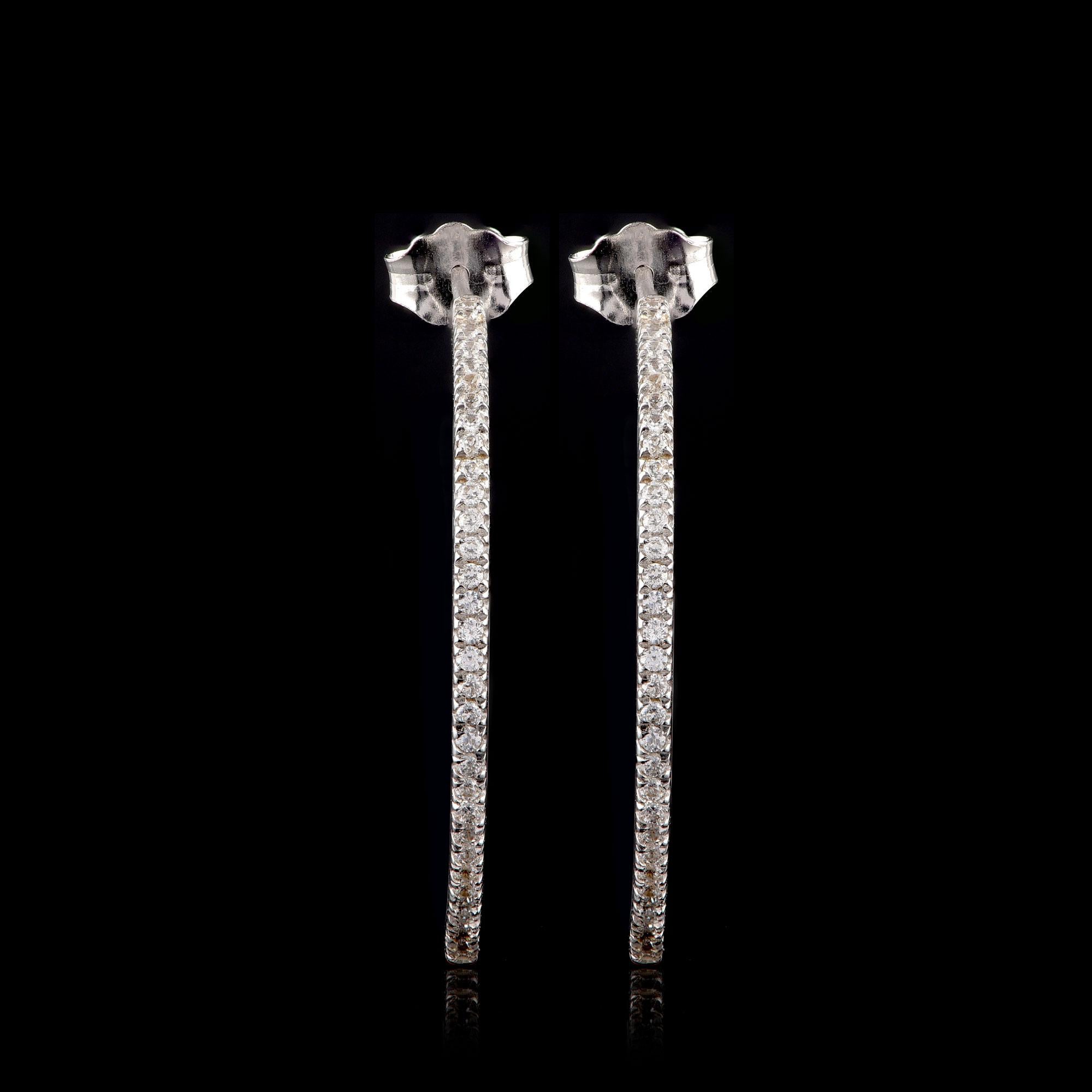 These designer hoop earrings feature 118 brilliant-cut diamond set in prong setting and hand-crafted by our in-house experts in 18-karat white gold. The diamonds are graded H-I Color, I2 Clarity.