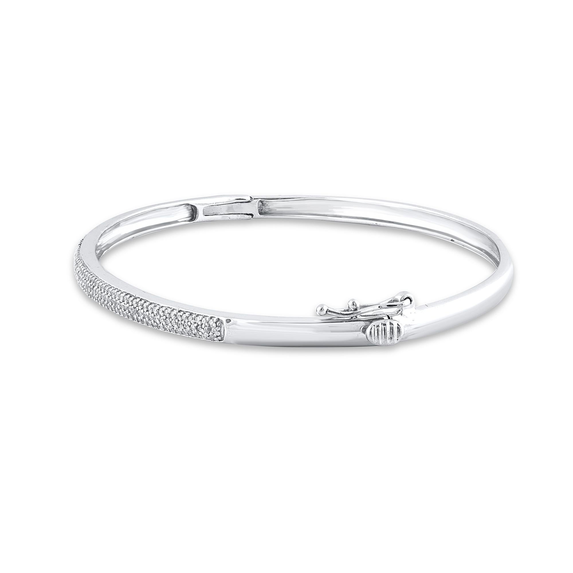 Add a touch of sparkle to any look with this sleek diamond bangle. Embedded with 169 round-cut diamonds set in pave setting and crafted by our inhouse experts in 18 Karat White gold. The total diamond weight is 0.50 carat and it shines brightly in