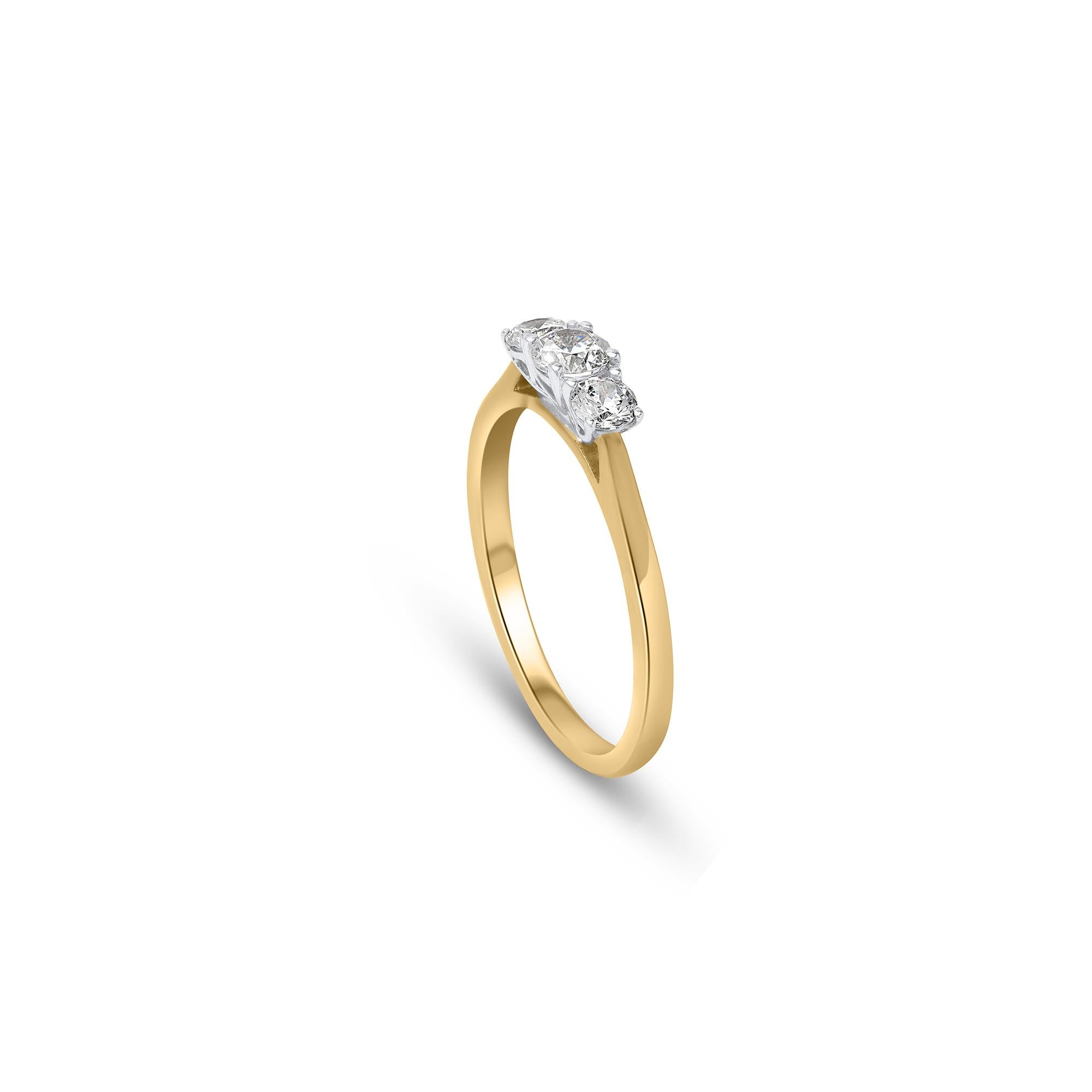 A sleek and timeless 3 stone engagement ring. Crafted by our in-house experts in 18 kt yellow gold and beautifully studded with three brilliant natural diamond set in prong setting.  Diamonds are graded H-I Color, I1 Clarity. 

Metal color and ring