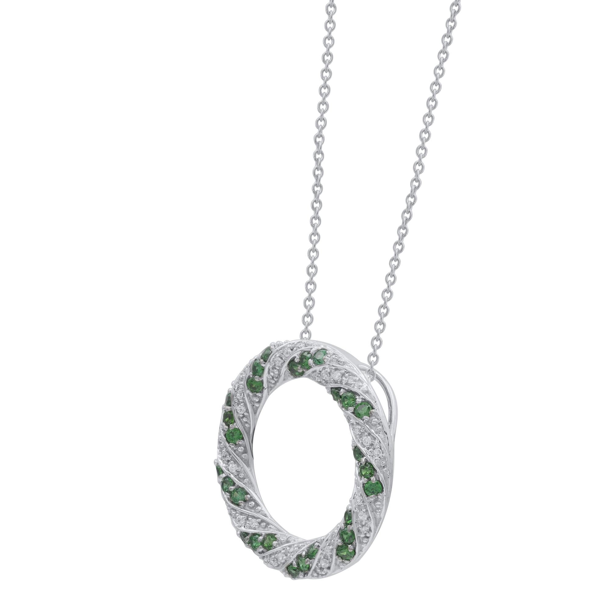 Create a casual yet elegant look with this green emerald and diamond open circle pendant. These circle pendant are studded with 27 green emerald  and 36 round natural diamonds in pave, prong setting in 18kt white gold. Diamonds are graded as H-I