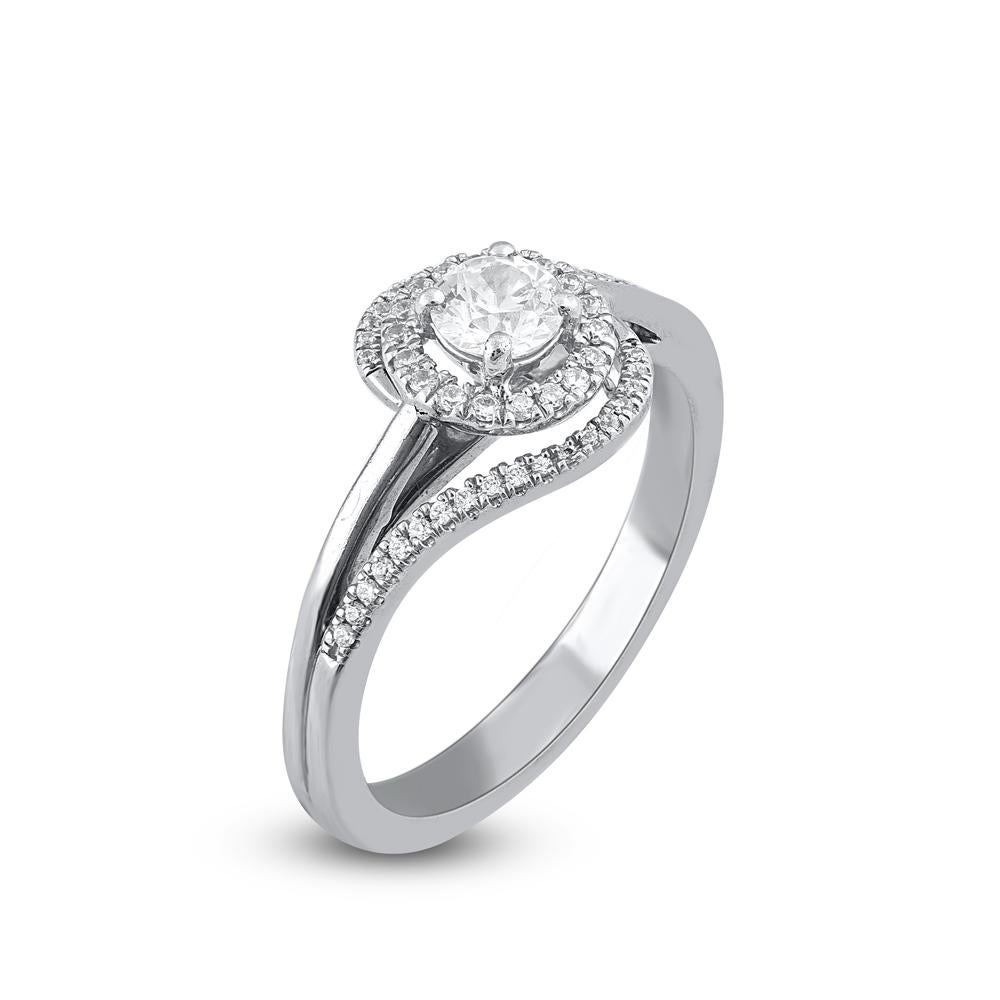 Make lifelong memory with this enticing curve design diamond Engagement ring. The ring is crafted from 18 karat White Gold and it features 0.32ct of center stone and 0.18ct of 54 white diamonds set in prong setting with G-H color SI1 clarity and a