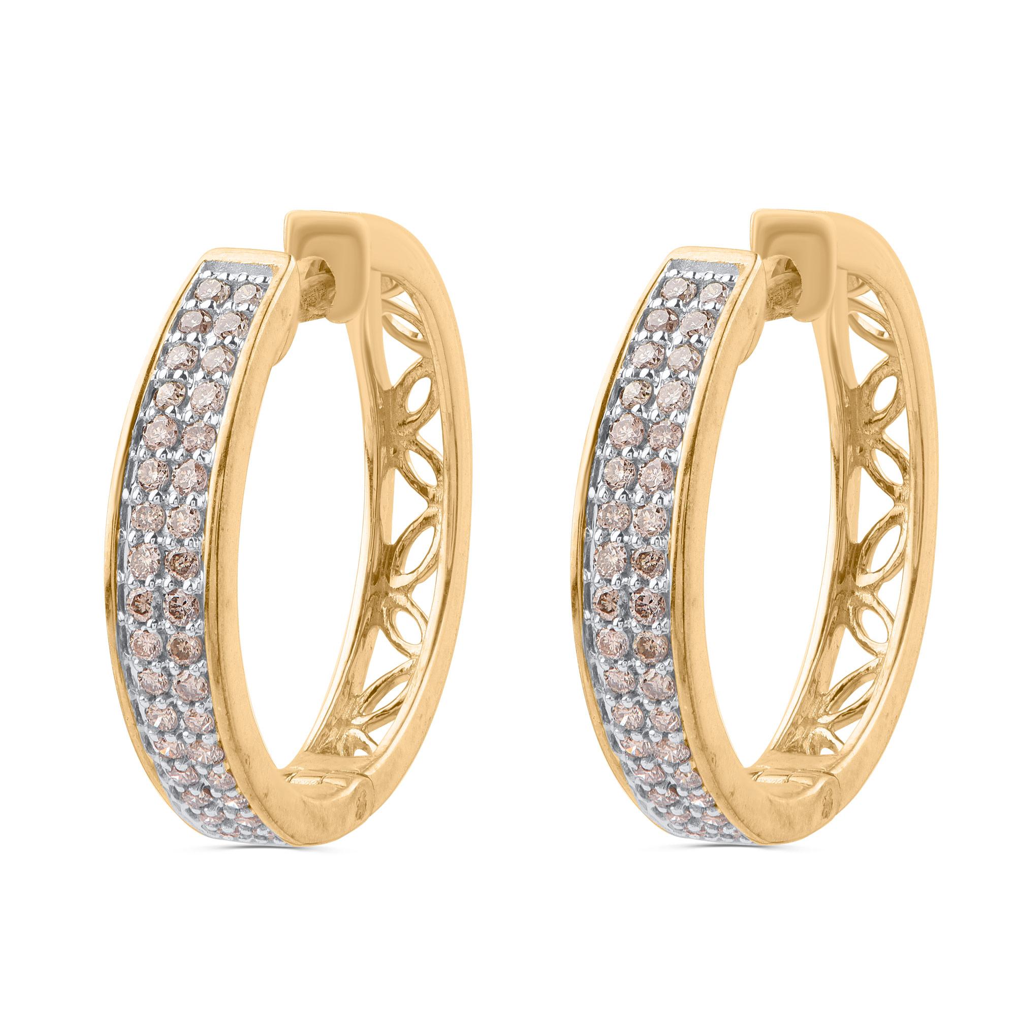 These diamond accented hoop earrings are crafted by our craftsmen in 10 kt yellow gold and embedded with 68 round-cut diamonds beautifully set in micro-pave setting. The diamonds are graded K-L-M Color. These hoop earrings hold comfortably with