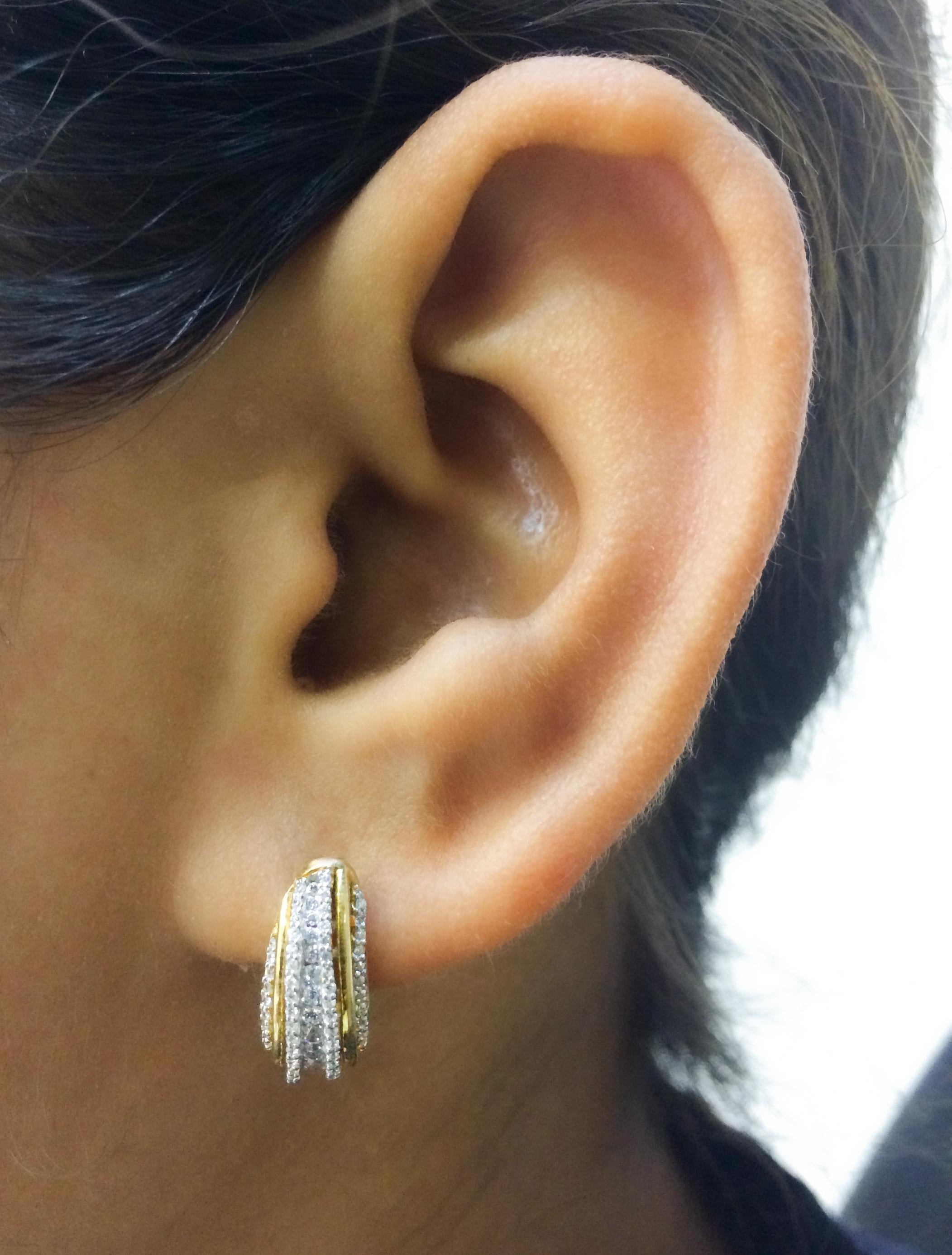 Adorn your formal wear with extra glitz when you put on these hoop huggie earrings. Expertly crafted in 14K White Gold,  earring is cleverly filled with 152 round diamond set in stackable prong and channel setting, H-I color I2 clarity. Captivating
