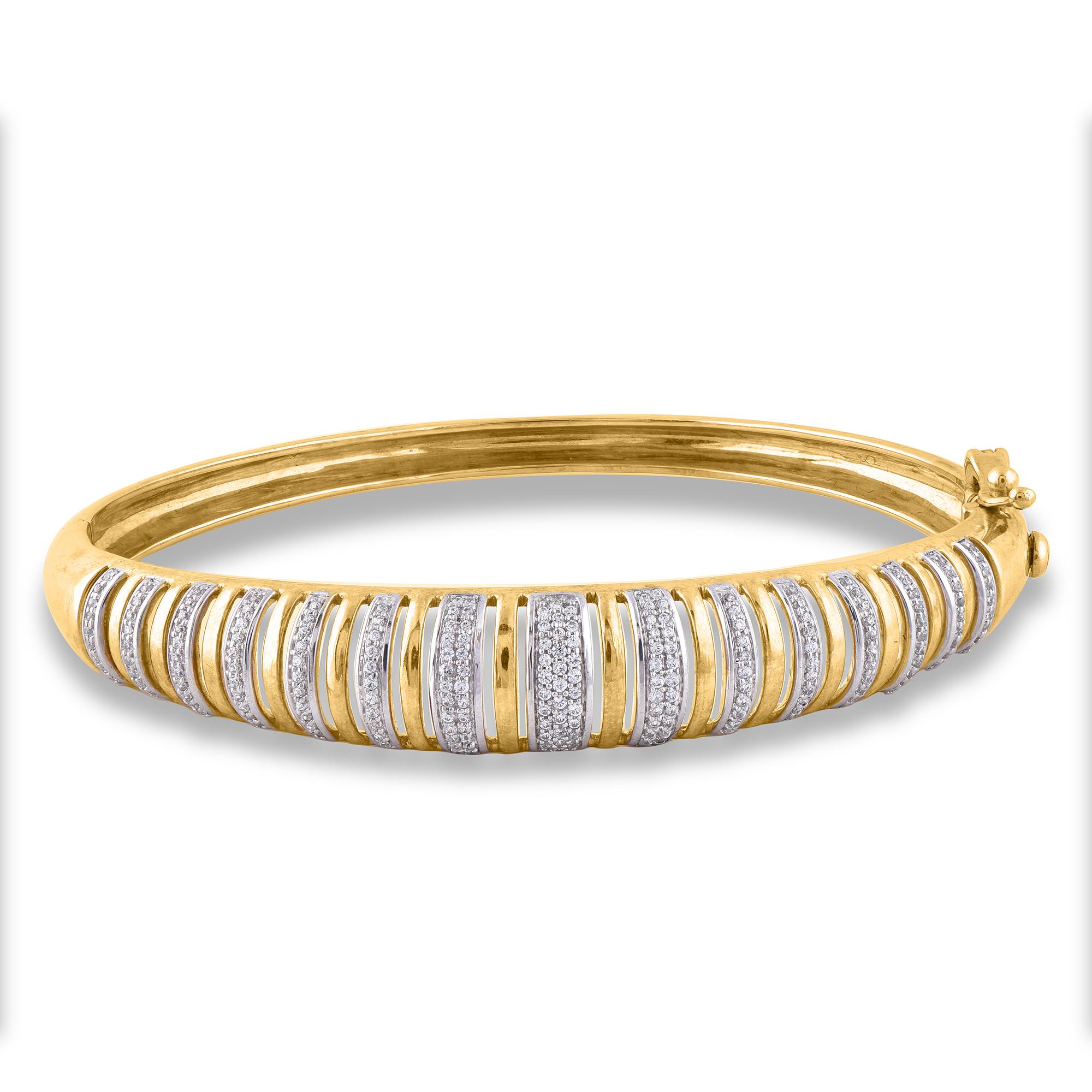 Truly exquisite, she'll admire the effortless look of this graceful diamond bangle. This designer diamond bangle features 207 round brilliant-cut diamond set in bezel setting and crafted by our inhouse experts in 14 karat yellow gold. The total