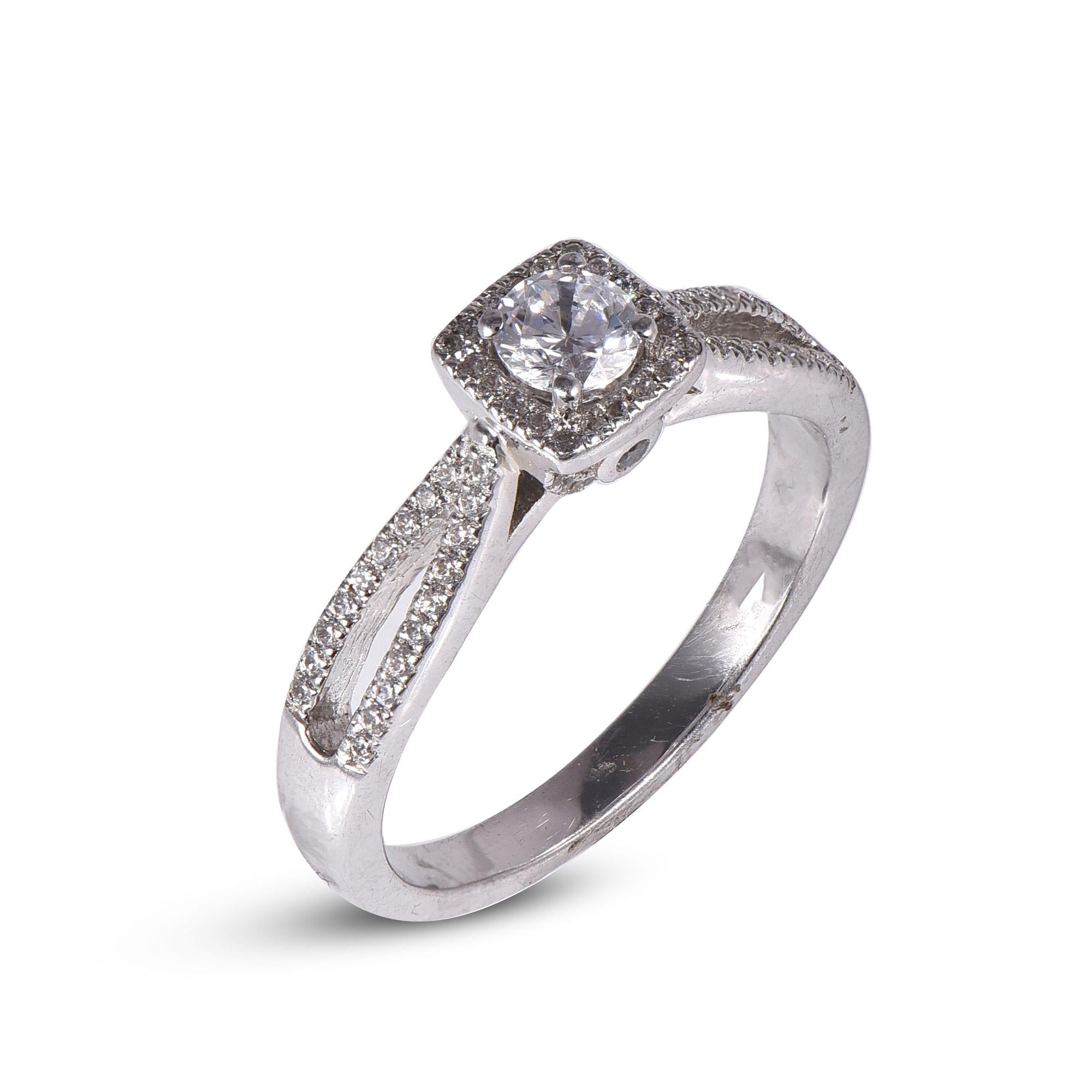Simply stunning engagement ring features 0.25 ct centre stone and 0.25 ct diamond frame and split shank lined diamonds. This ring is handcrafted in 18 kt white gold and embellished with 79 brilliant round diamond set in prong and micro-pave setting.