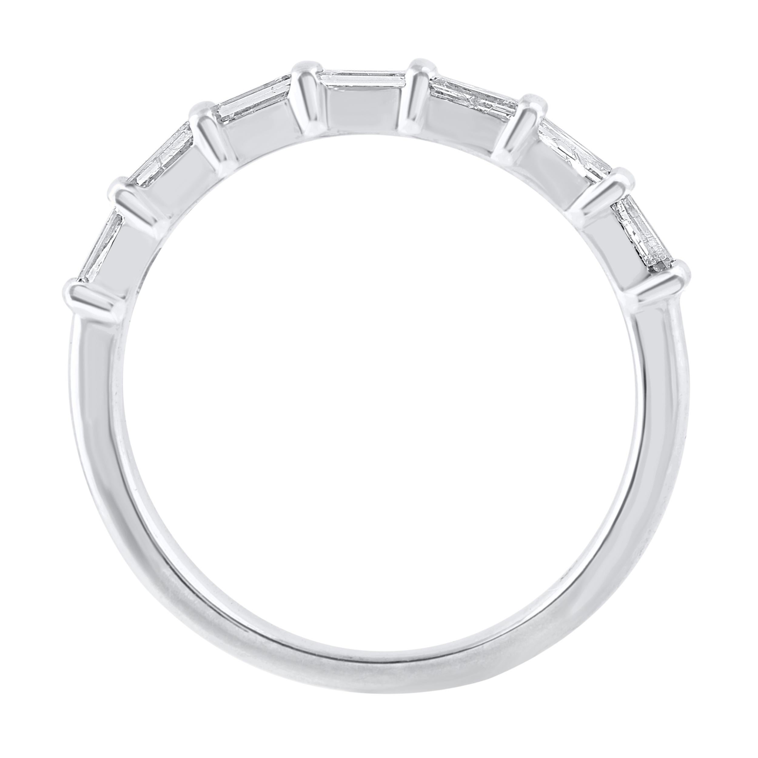 This beautiful seven stone band ring features shimmering baguette diamonds in channel setting. crafted in 14 karat white gold. The ring is studded with a total of 7 baguette cut natural diamonds and the total diamond weight is 0.55 carat. The