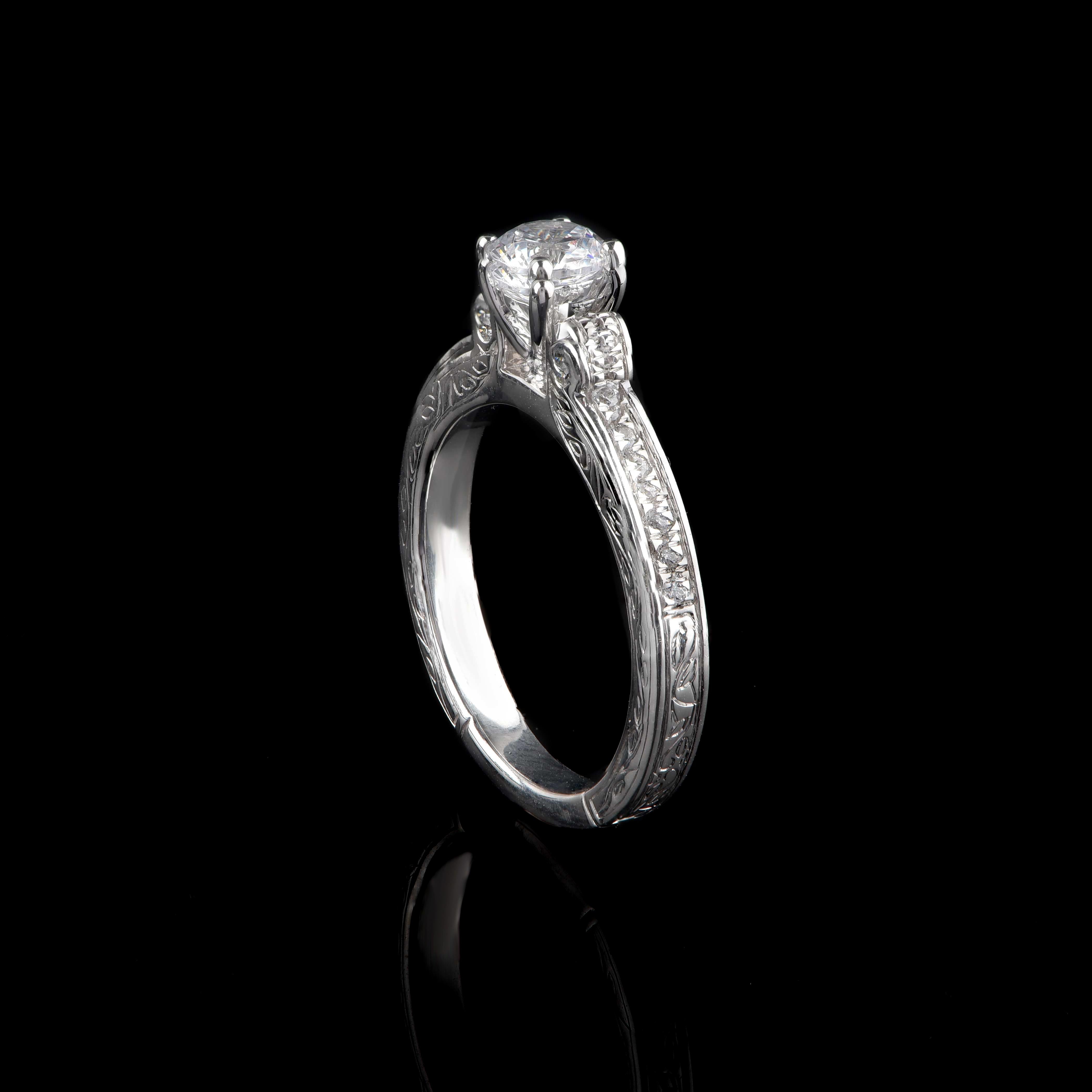 This diamond bridal ring features 24 brilliant-cut diamond and 1 GIA certified centre stone in prong and flush setting. The ring is crafted beautifully in 18-karat white gold. The diamonds are graded H Color, SI1 Clarity. 

Metal color and ring size