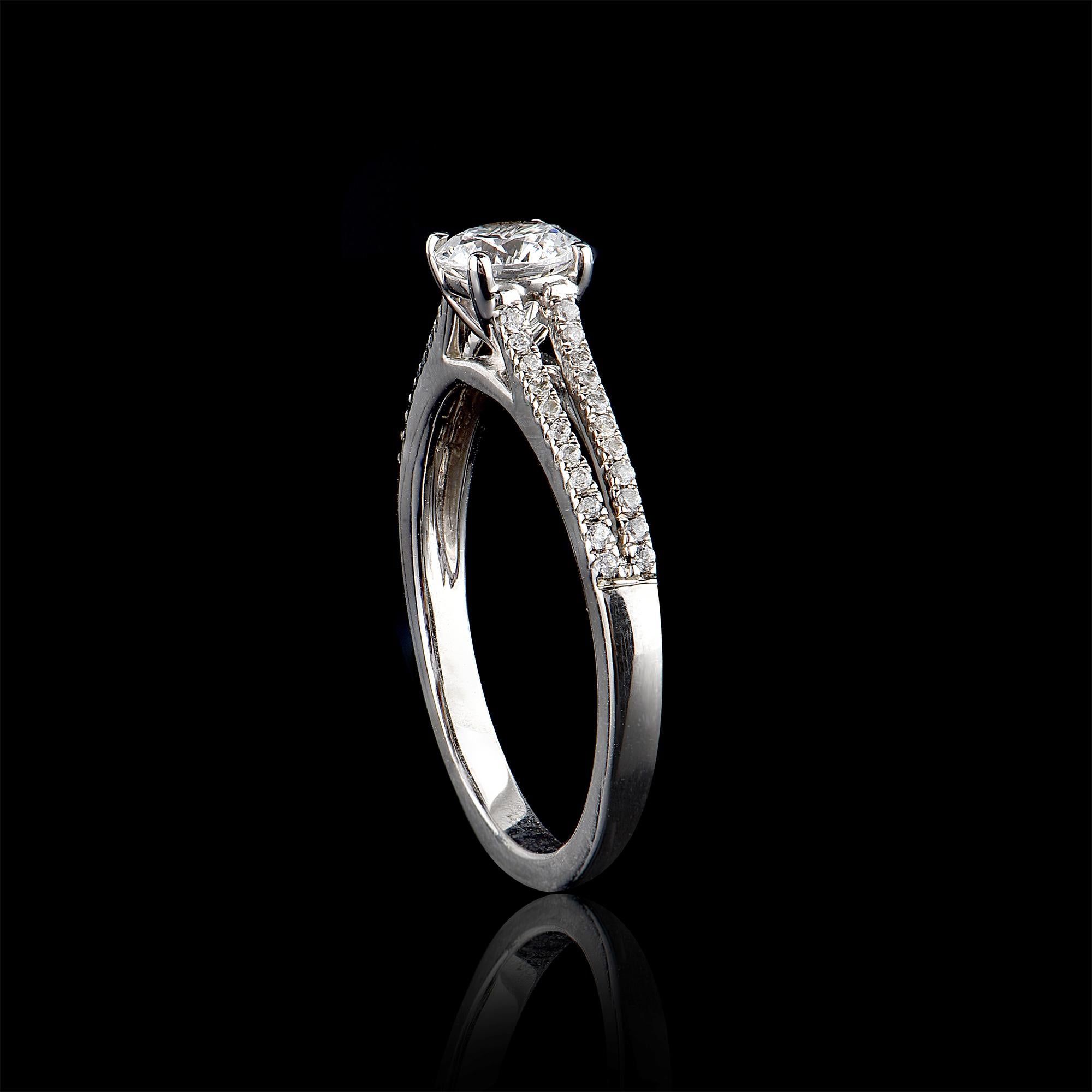Give a touch of glamour to your fine jewelry collection with this diamond petal engagement ring. It features 0.60 ct centre stone and 0.15 ct round brilliant diamond on split shank set in micro pave and channel setting. The diamond are natural, not