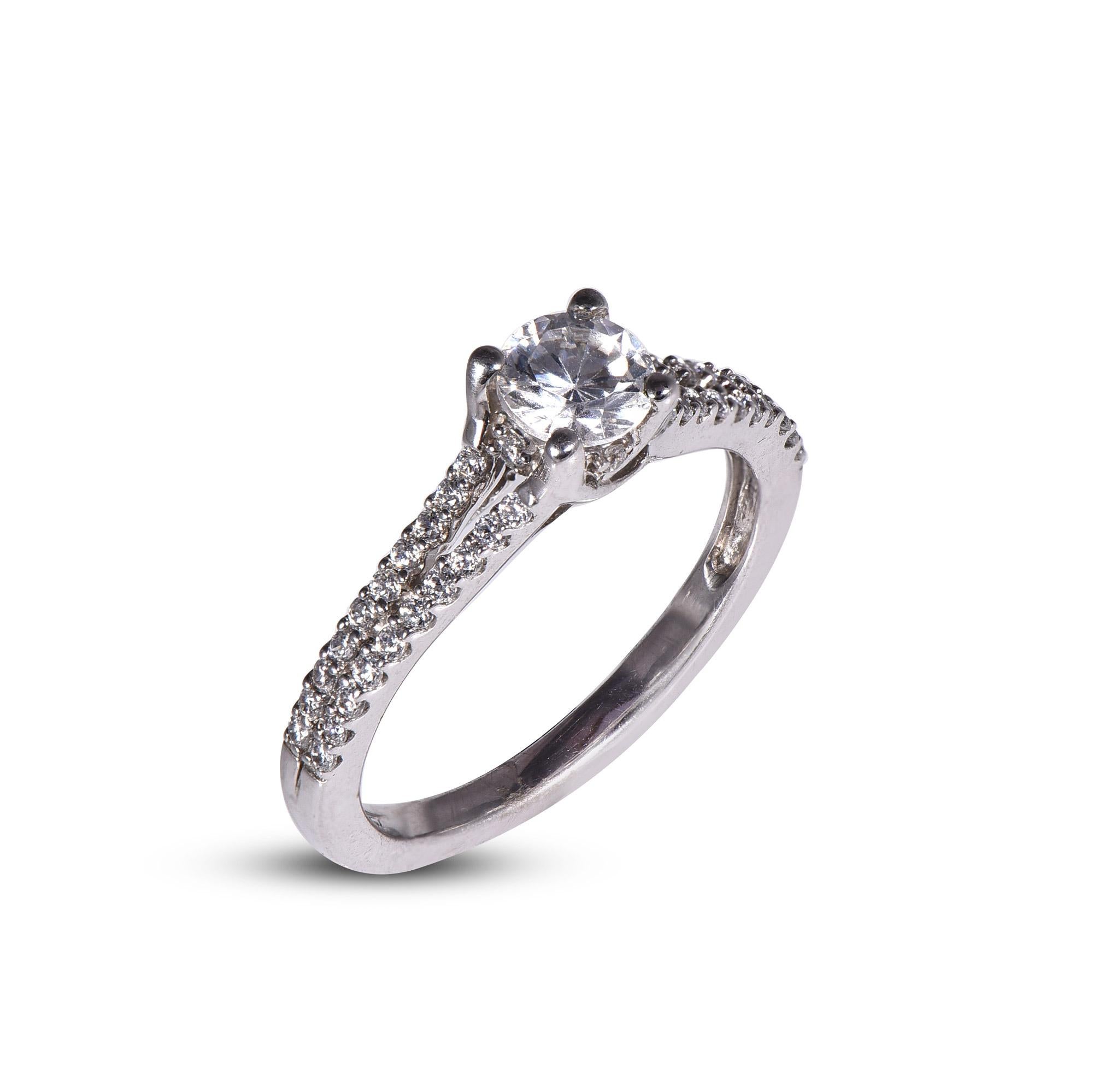 With one look of this Beautiful Round Split Shank Diamond Engagement Ring crafted in 18 kt white gold. This ring is beautifully designed and studded with 0.50 ct center stone and 0.25 ct brilliant cut diamonds on split shank in prong setting. We