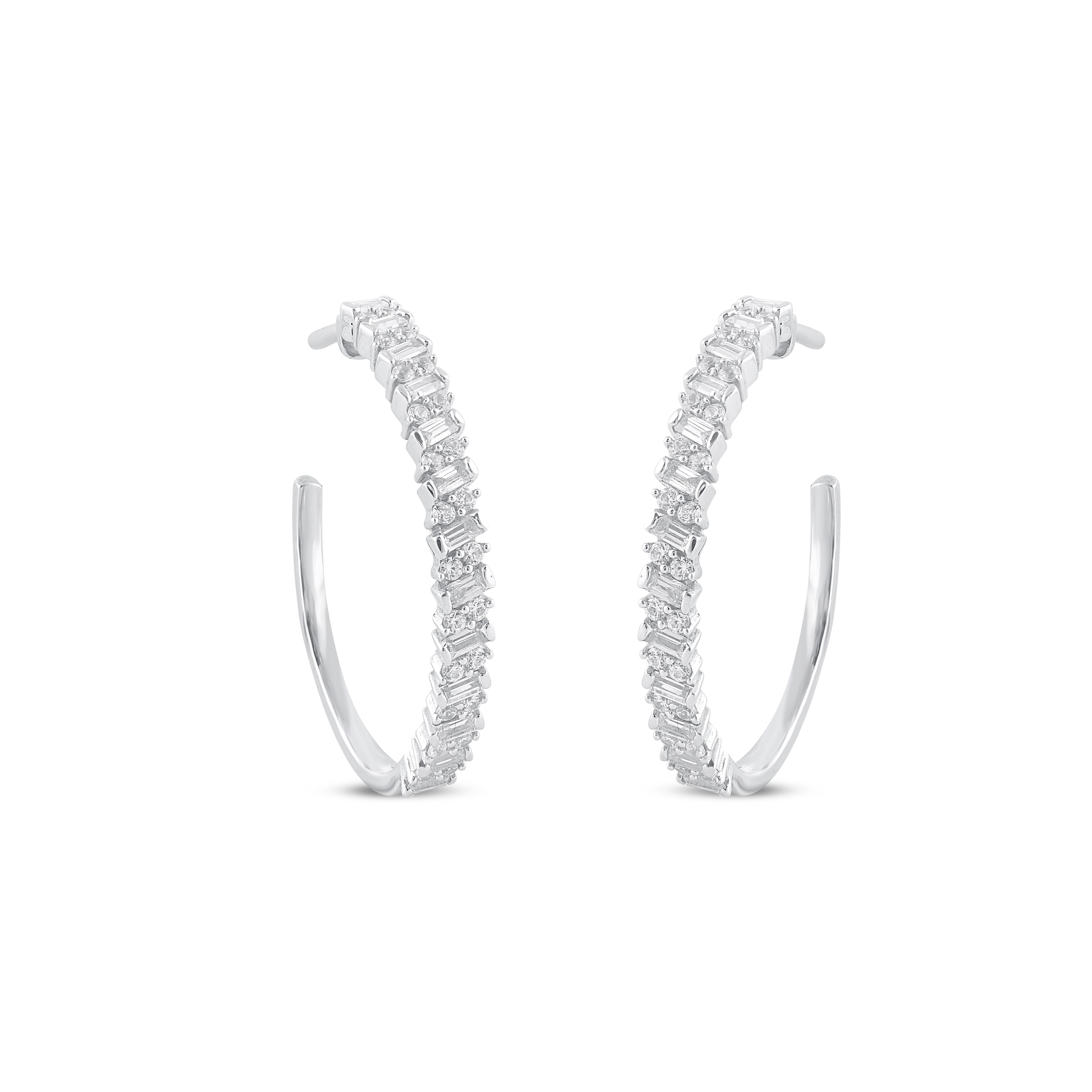 A sparkling delight, these diamond hoop earrings fit her charming aesthetic. Embellished with 48 round and 26 baguette diamond set in prong & channel setting, and dazzles with H-I color I2 clarity. Captivating with 1.00 Carat and secures comfortably