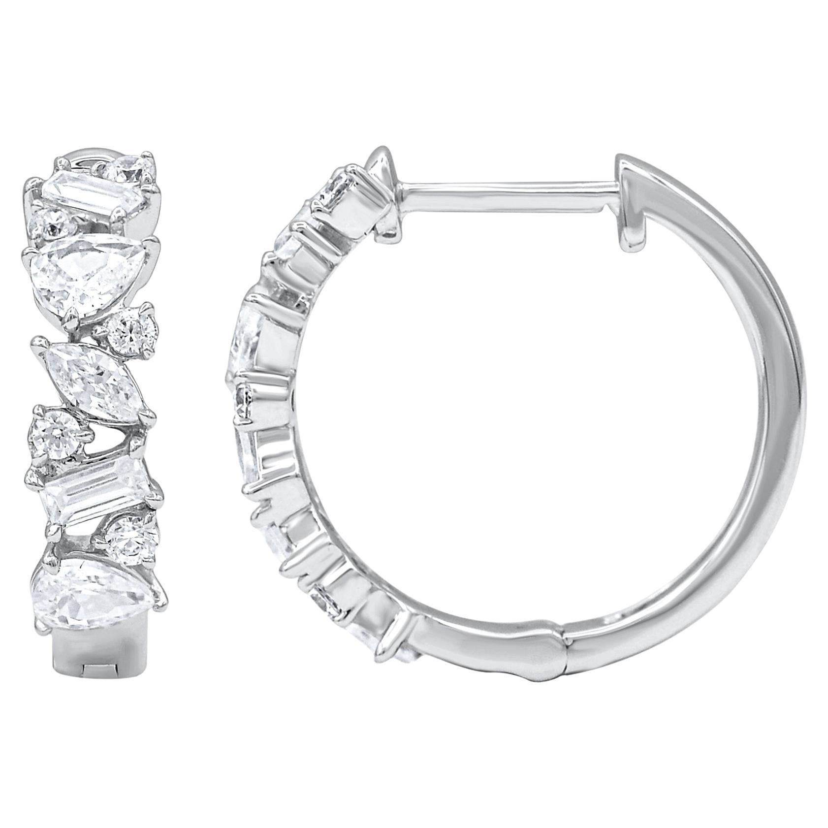 Timeless and elegant, these diamond hoop earrings are a style you'll wear with every look in your wardrobe. Crafted in 14 karat white gold with 20 Pear, Marquise, baguette & brilliant cut diamond in prong setting. Total diamond weight is 1.0 carat.
