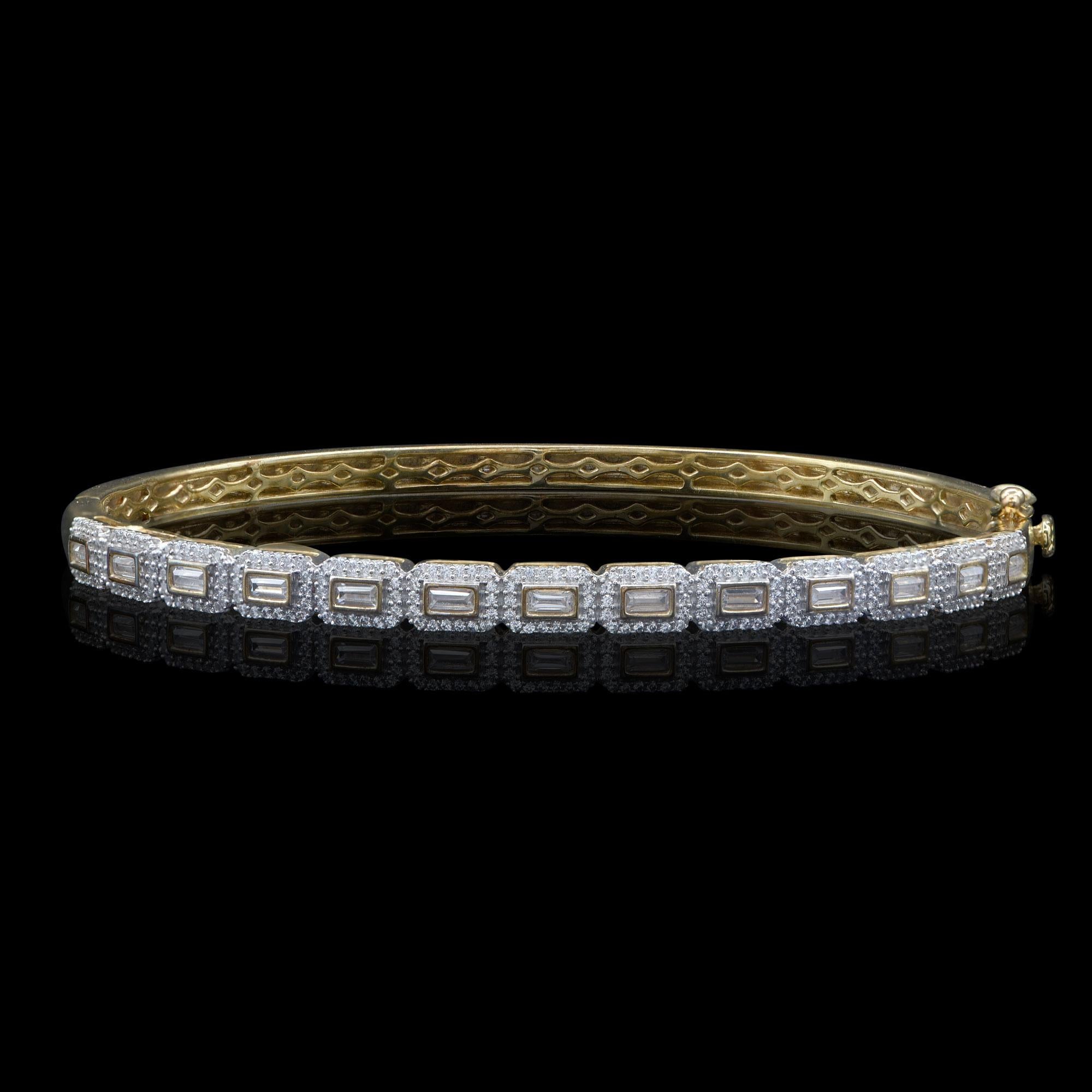 Exquisitely designed, this diamond bangle is studded with 234 brilliant and 13 baguette cut diamonds in stackable prong and prong setting. The bangle is hand-crafted by our skillful craftsmen in 18-karat yellow gold. The diamonds are graded H-I