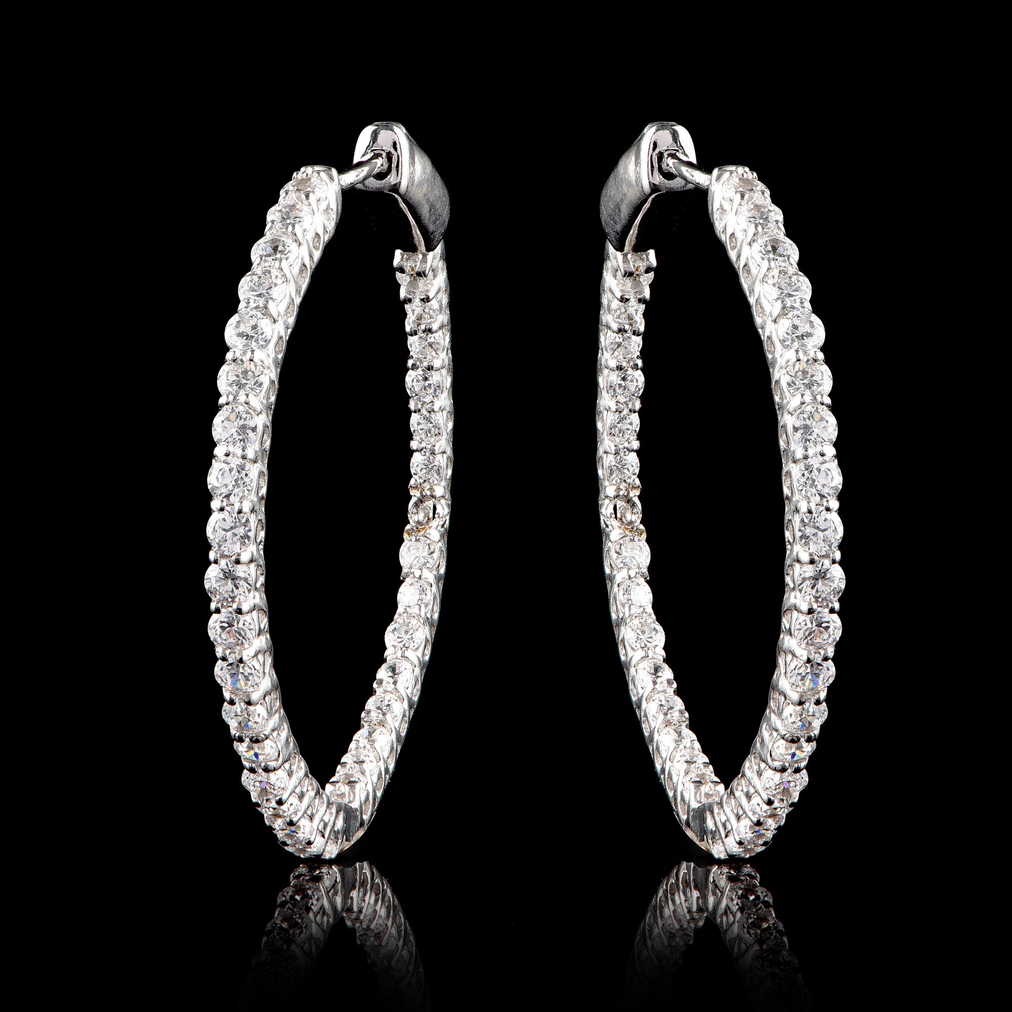 Classic and always in trend, these inside out hoop earrings are designed in 18 Karat White Gold and Embellished with 68 brilliant-cut diamonds in prong setting. The diamonds are graded H-I Color, I2 Clarity. 
