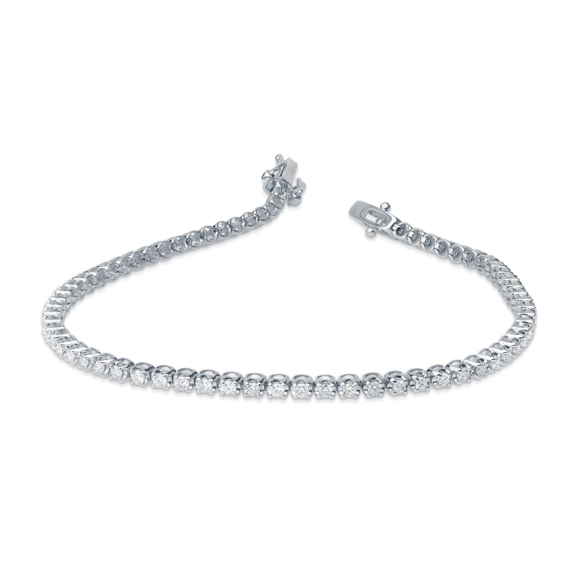 A classic tennis bracelet – perfect accessory for women with everyday attire. Elegantly designed in 10 kt white gold and embellished with 72 brilliant natural diamonds in prong setting. Diamonds are graded H-I Color, I2 Clarity. 
