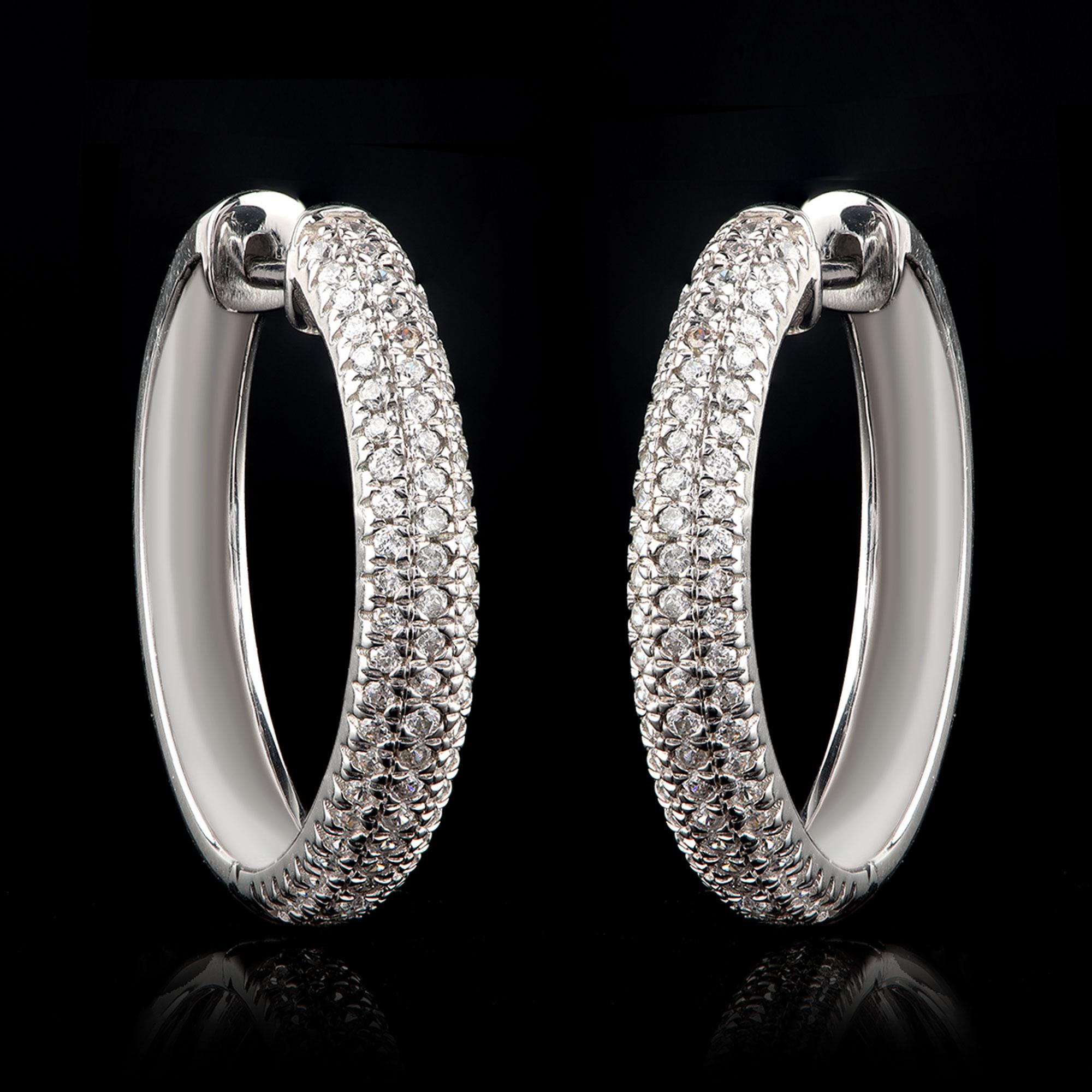 These diamond hoop earrings look truly captivating with 146 brilliant-cut diamonds in micro-pave setting and crafted in 18 KT white gold. The diamonds are graded H-I Color, I2 Clarity.