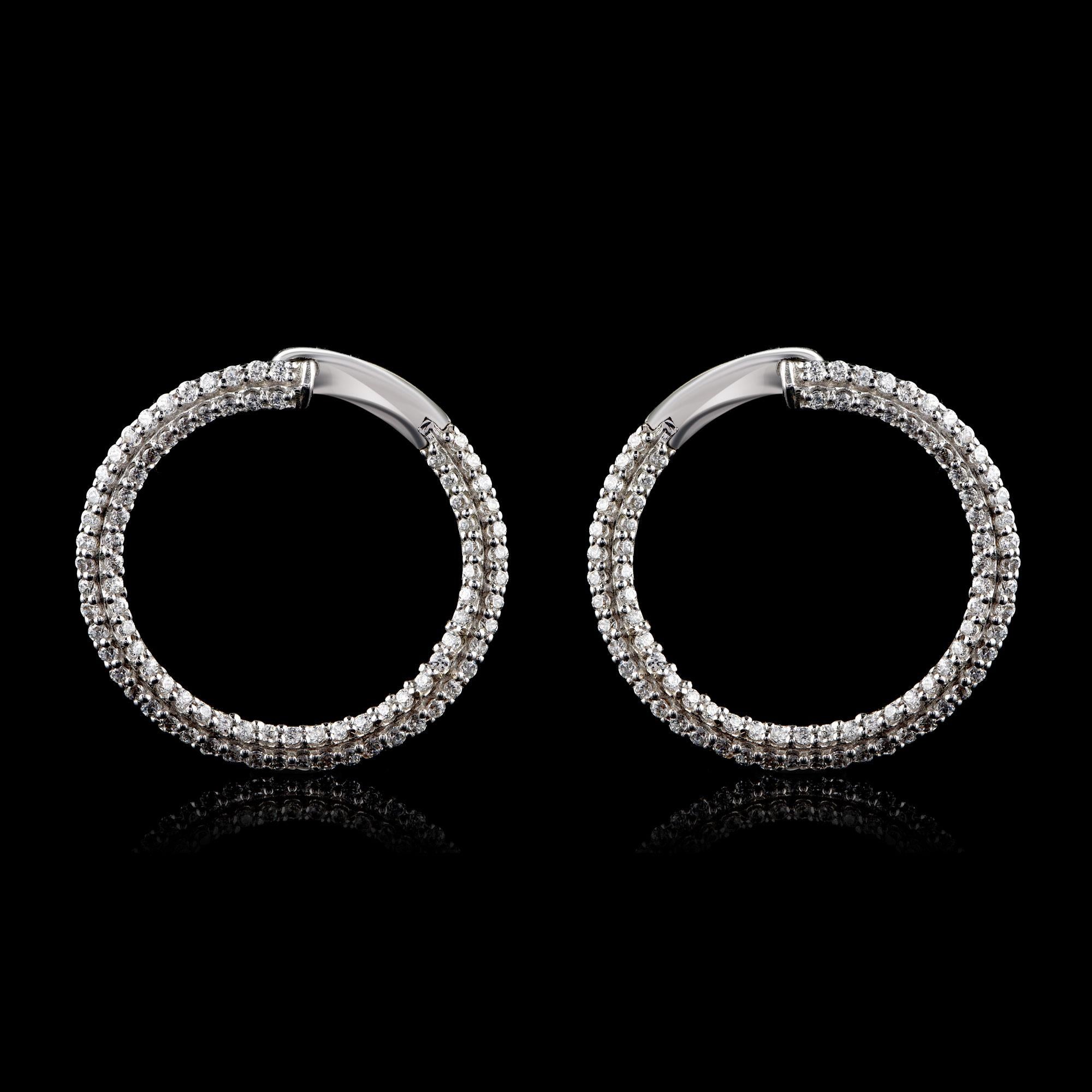 These hoop earrings are embedded with 172 brilliant-cut diamonds in prong setting and hand-crafted in 18-karat white gold. The diamonds are graded H-I Color, I2 Clarity.