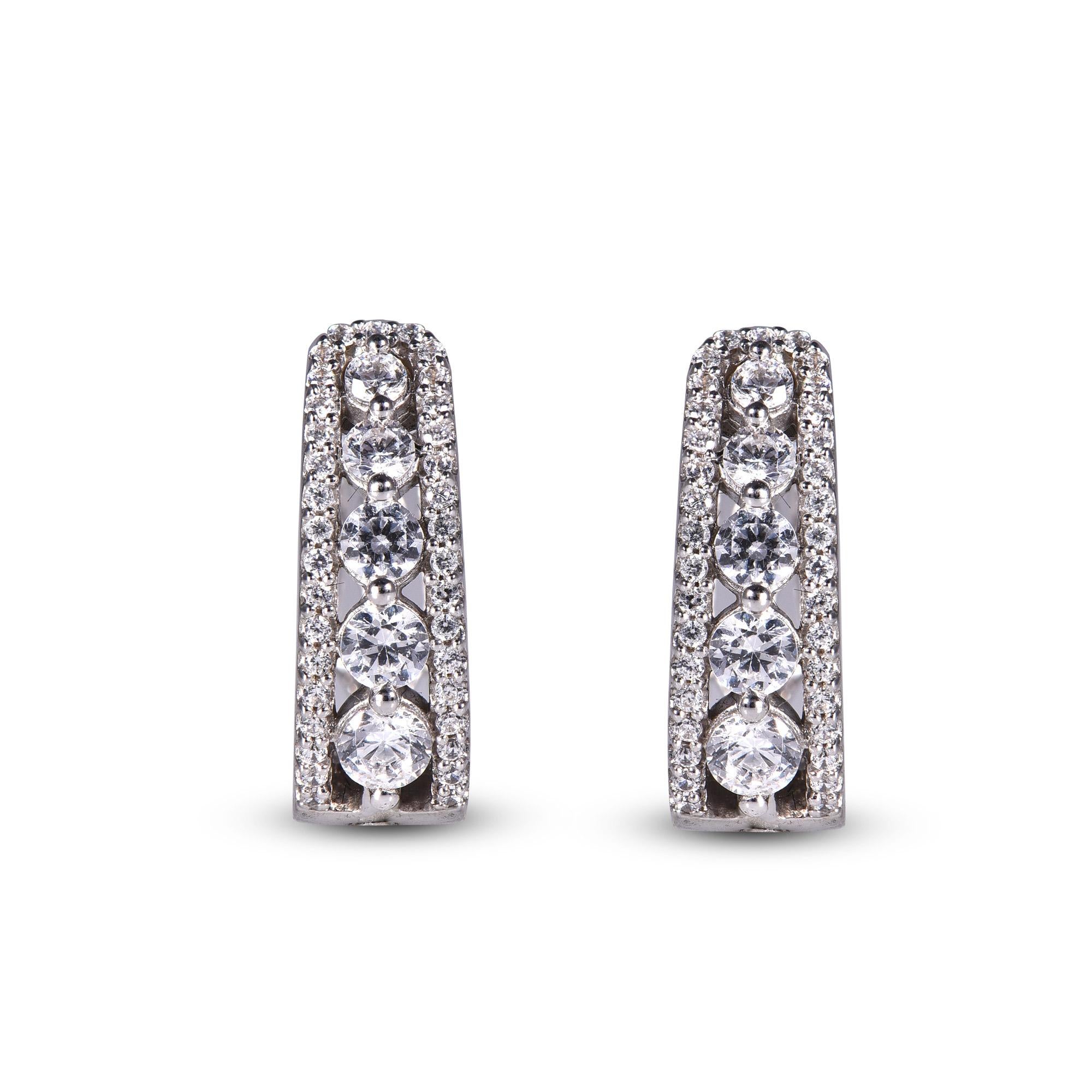 These exquisite diamond hoop earrings offer beauty equaled only to her own. These earrings crafted in 14 karat in white gold and feature clusters of 80 round brilliant dazzling diamond set in prong setting. These timeless hoop earrings that secure
