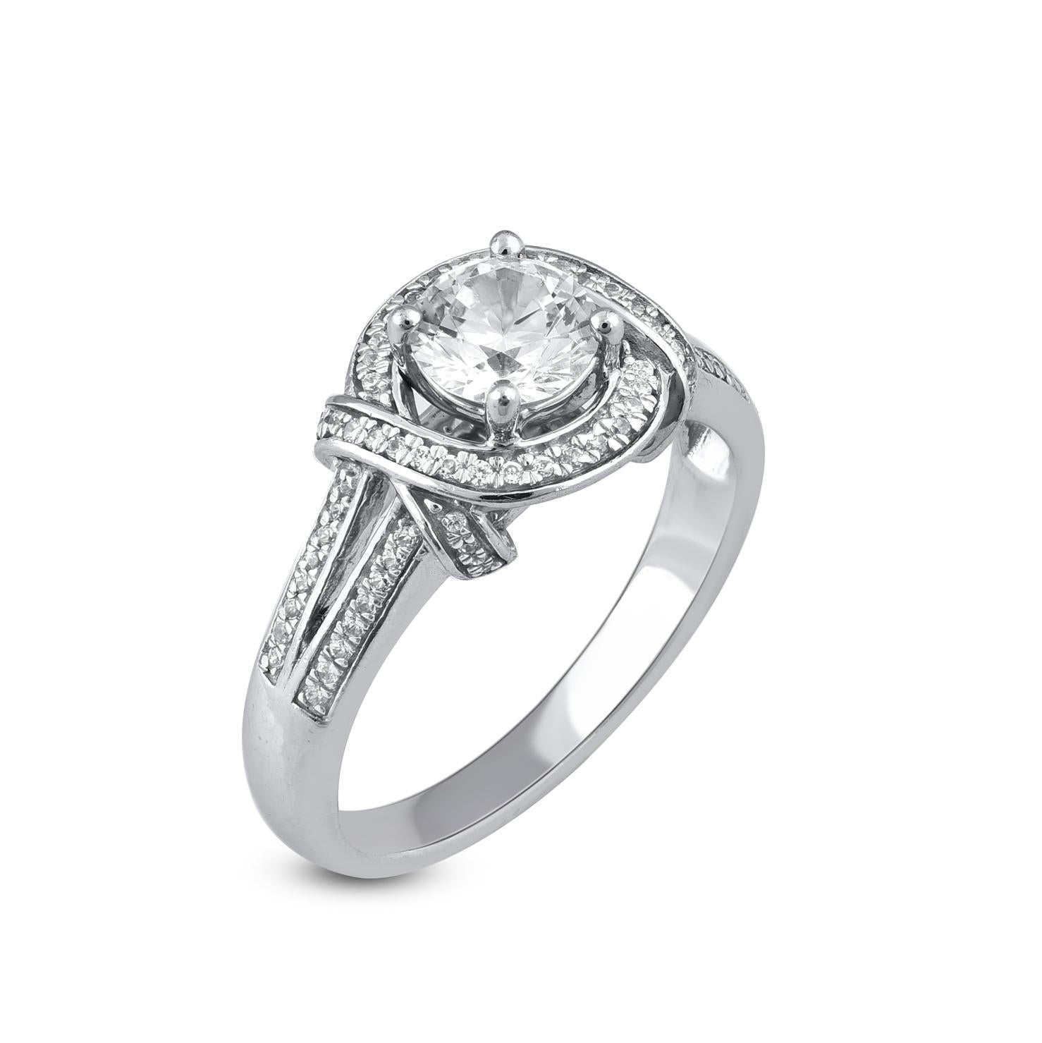 An Elegant Statement Of Style, This Diamond Engagement Ring With Love Knot Shank Design Showcases 0.82ct of center stone and  0.18ct of small round Diamonds Beautifully set in prong and channel setting. Shines with G-H colour and SI1 clarity. 