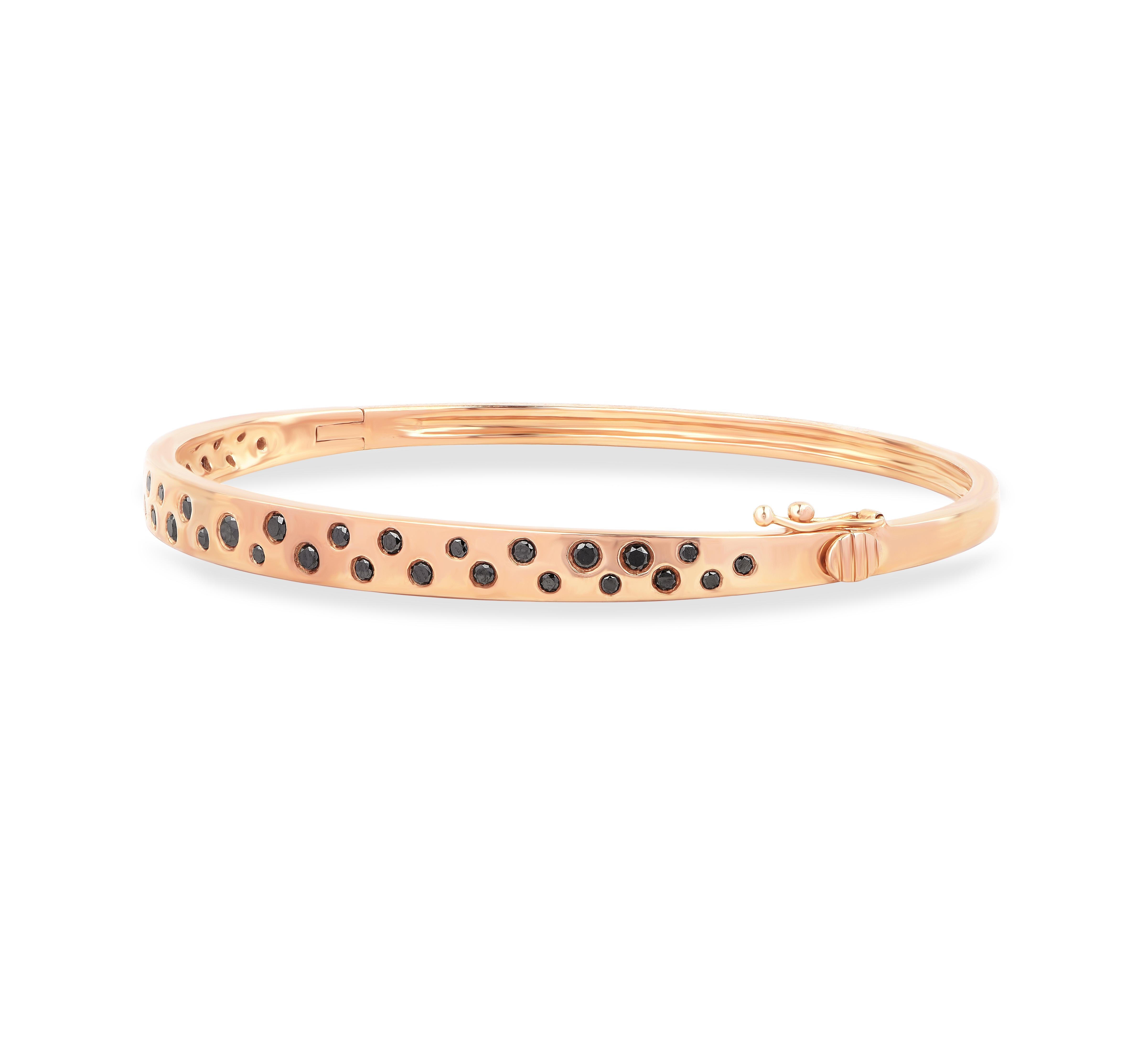 Studded with 38 brilliant cut treated black diamonds in flush setting and made by our skillful craftsmen in 18-karat yellow gold.  This designer bangle that will make a great gift for yourself or friends and family.  

This piece is made to order,