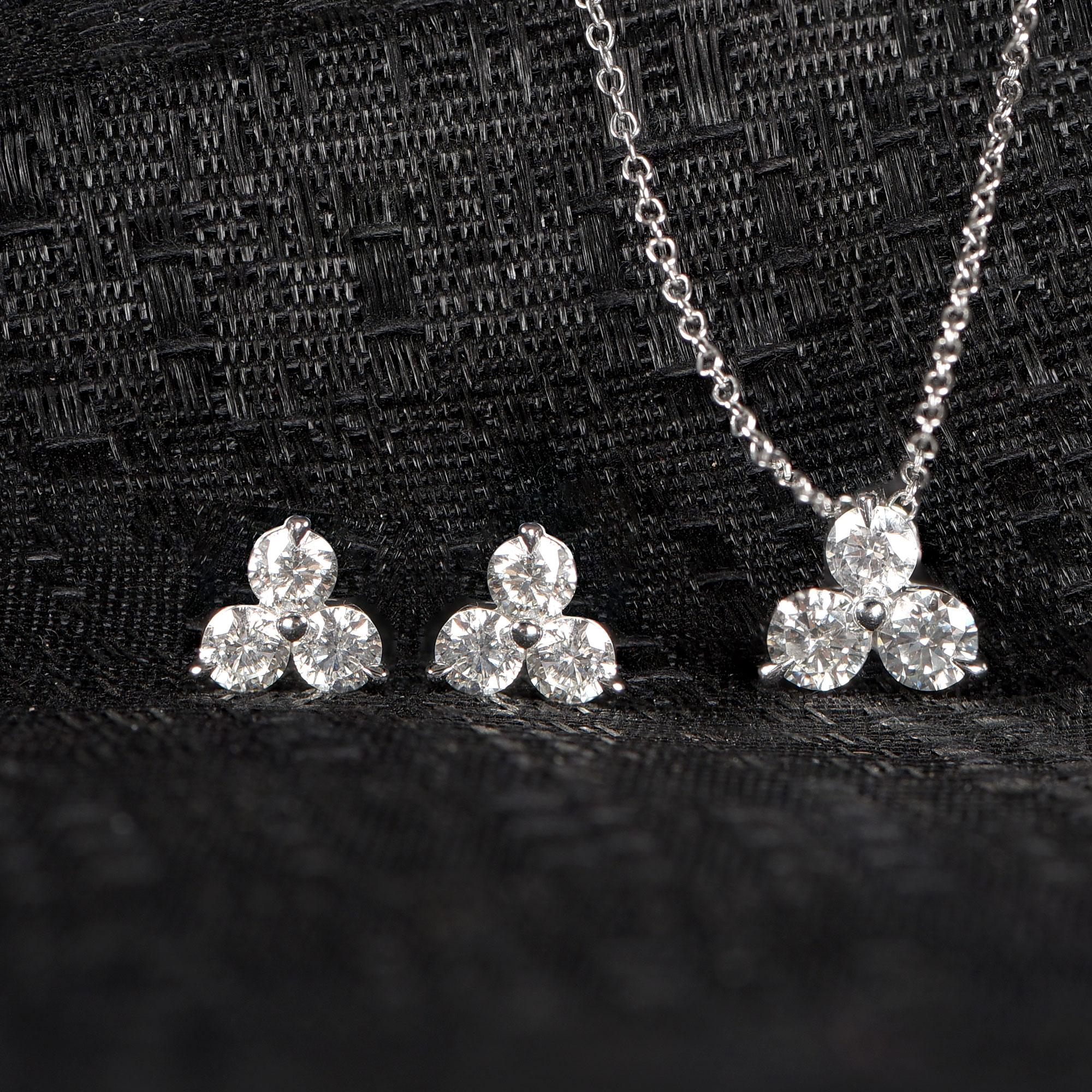 This diamond earring and pendant set glitters with a total of 9 brilliant-cut diamonds set in prong setting and handcrafted in 14-karat white gold. The diamonds are graded HI Color, I1 Clarity.
