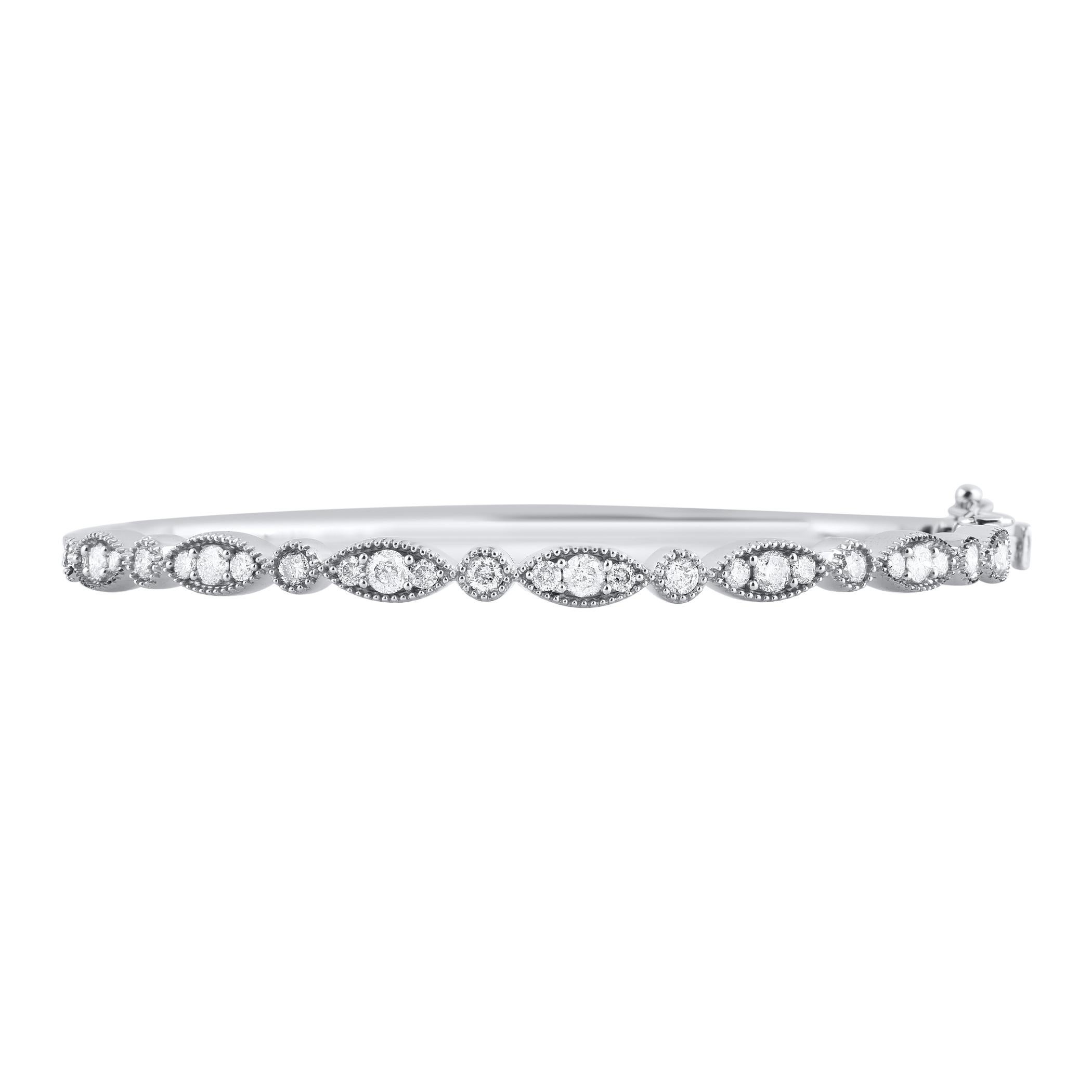 Enhance your everyday look with this diamond bangle bracelet. This Shimmering bangle bracelet features 29 natural round brilliant cut diamonds in prong and bezel setting and crafted in 18kt white gold. Diamonds are graded H-I color, I2 clarity. 
