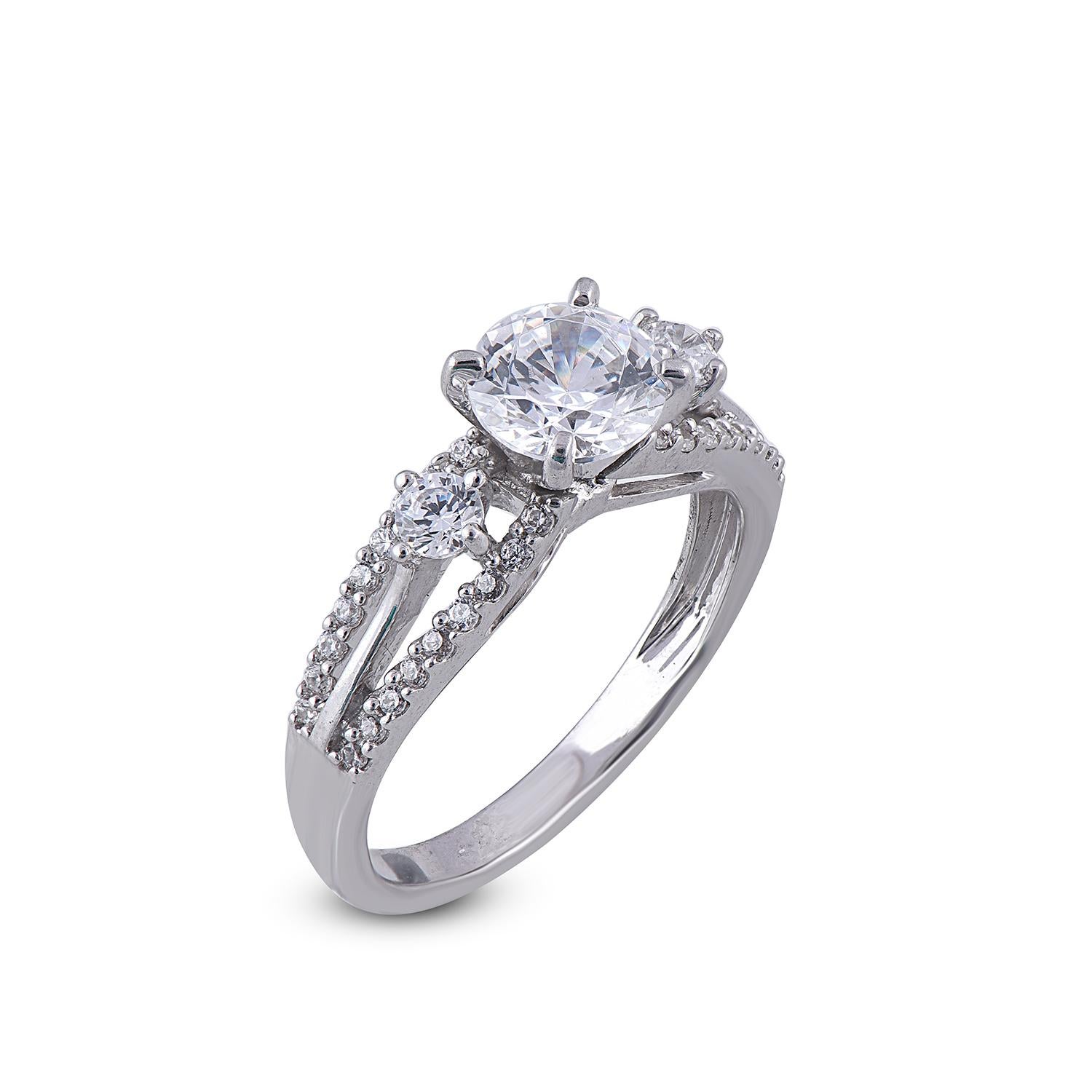 With one look of this Beautiful Round Split Shank Diamond Engagement Ring crafted in 18 Karat white gold. This ring is beautifully designed in 59 round diamond and studded with 1.00 ct centre stone and 0.33 ct diamonds on shank in prong and bezel