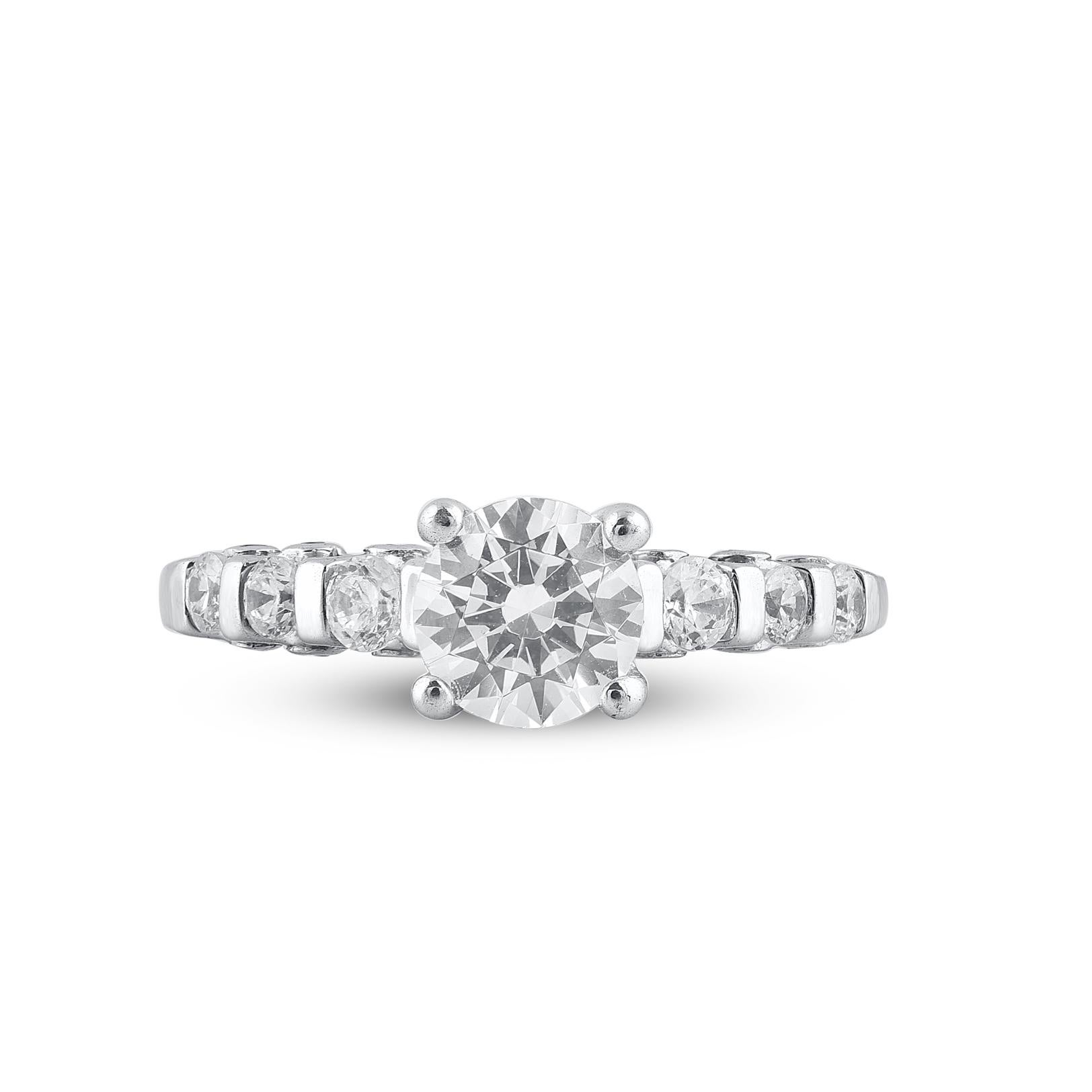 Honorez les femmes que vous aimez avec cette bague de fiançailles en or blanc 18 carats, composée de 21 diamants ronds en serti clos. Cette bague de fiançailles comporte une pierre centrale de 1,00ct et des diamants de 0,40ct sur la tige. Le diamant