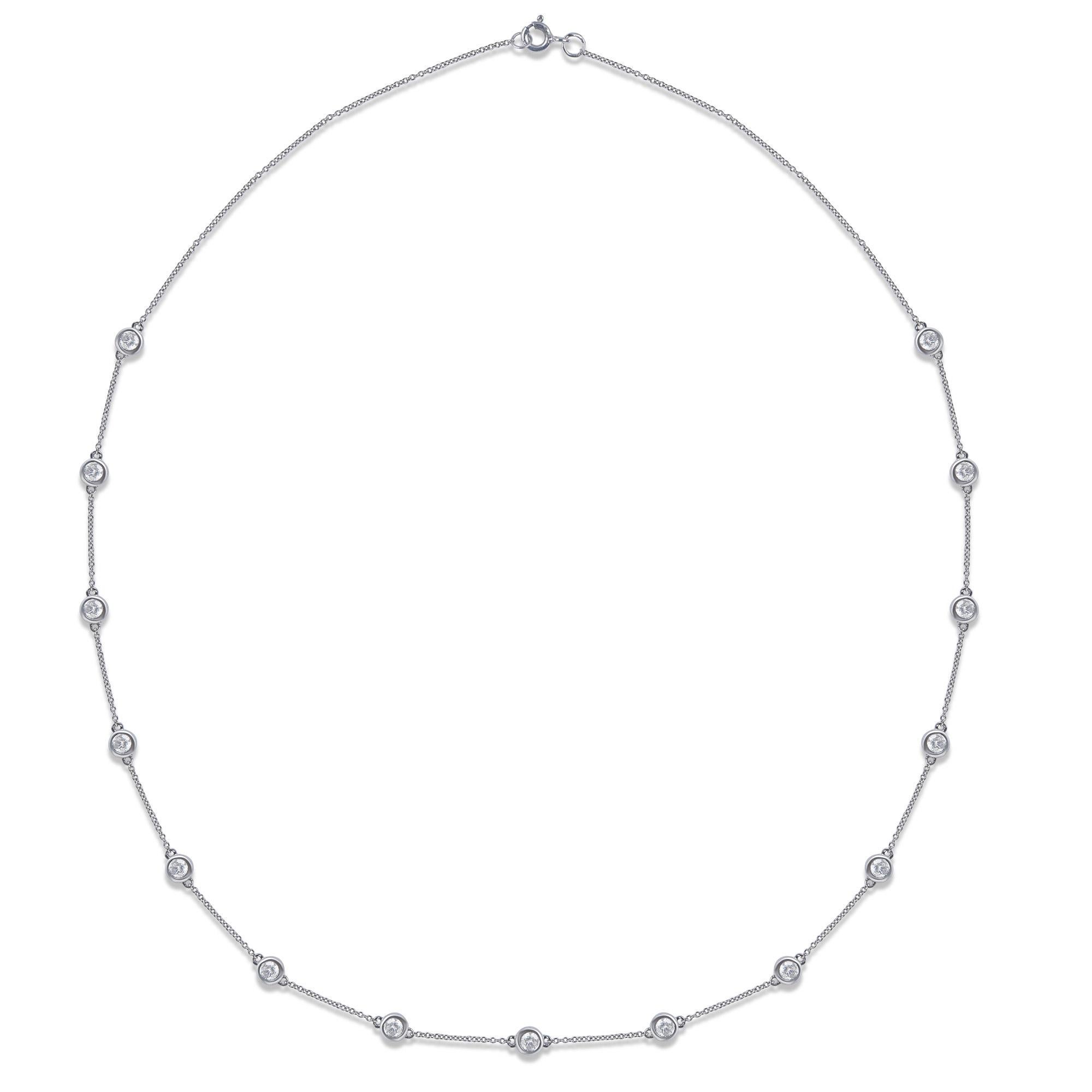 This elegant station necklace is hand-crafted by our in-house experts in 14-karat white gold and studded with 14 brilliant cut diamonds in bezel setting. The diamonds are graded HI colour, I2 Clarity. The length of the cable chain necklace is 18