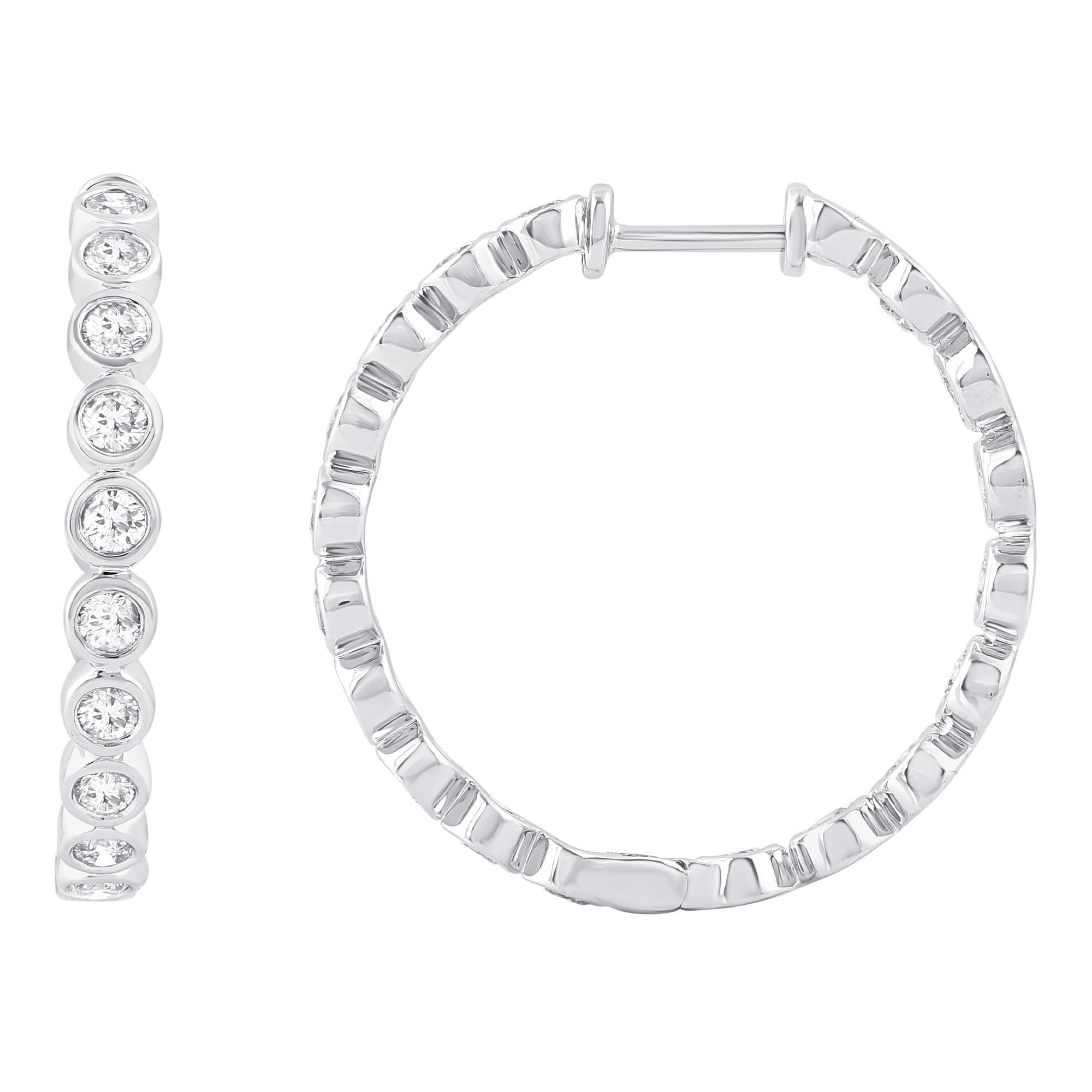 These exquisite diamond hoop earrings offer beauty equaled only to her own.These earrings are crafted in 14 karat white gold and features 36 round diamond set in bezel setting. These hoop earrings  secure comfortably with safety lock. The total