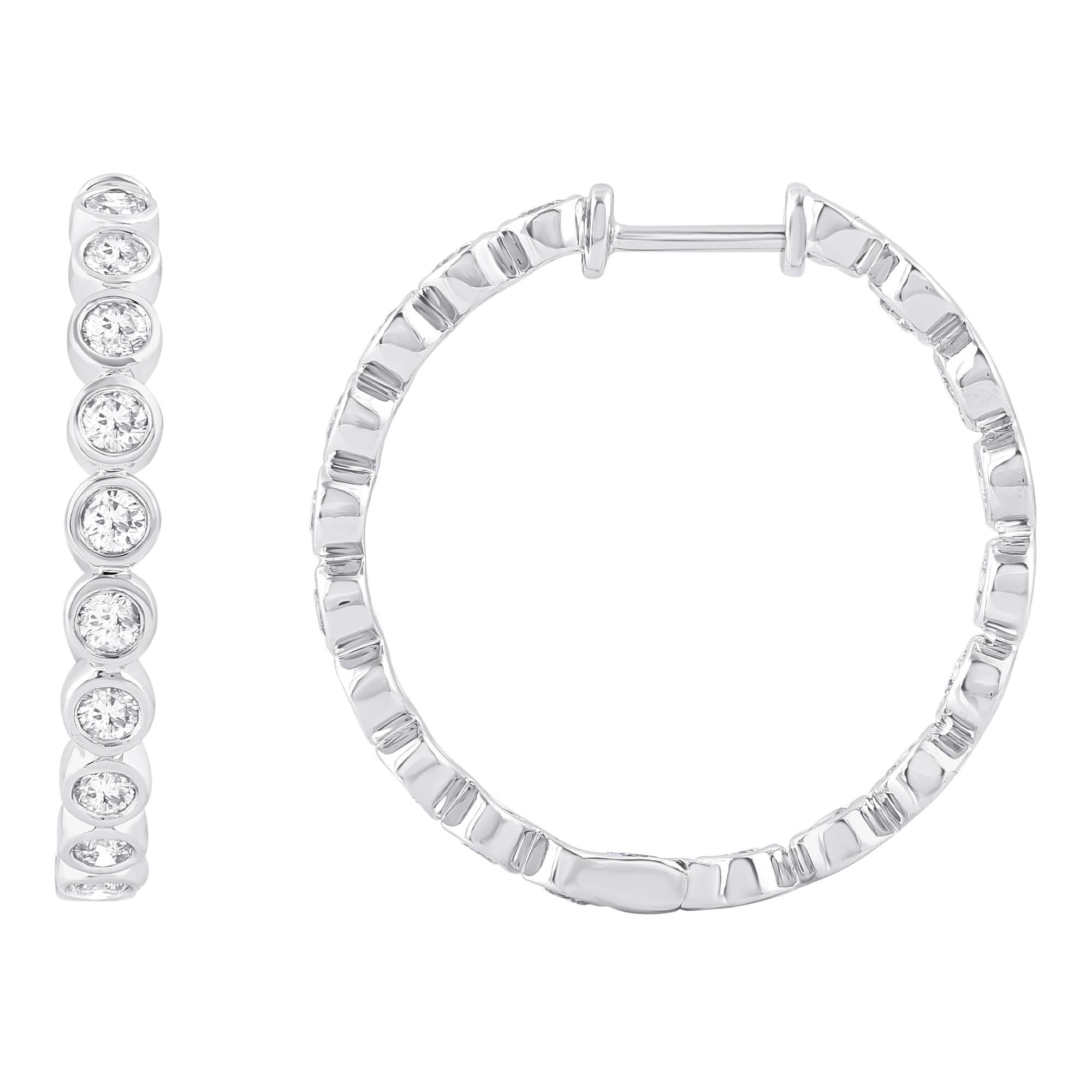 These exquisite diamond hoop earrings offer beauty equaled only to her own. These earrings are crafted in 14 karat white gold and features 36 round diamond set in bezel setting. These hoop earrings  secure comfortably with safety lock. The total