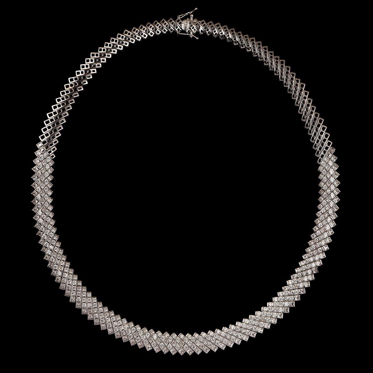 Exquisitely designed diamond mesh necklace studded with 136 brilliant cut and 205 princess cut diamonds in channel setting and fashioned in 18 karat white gold. The diamonds are graded H-I Color, I2 Clarity.