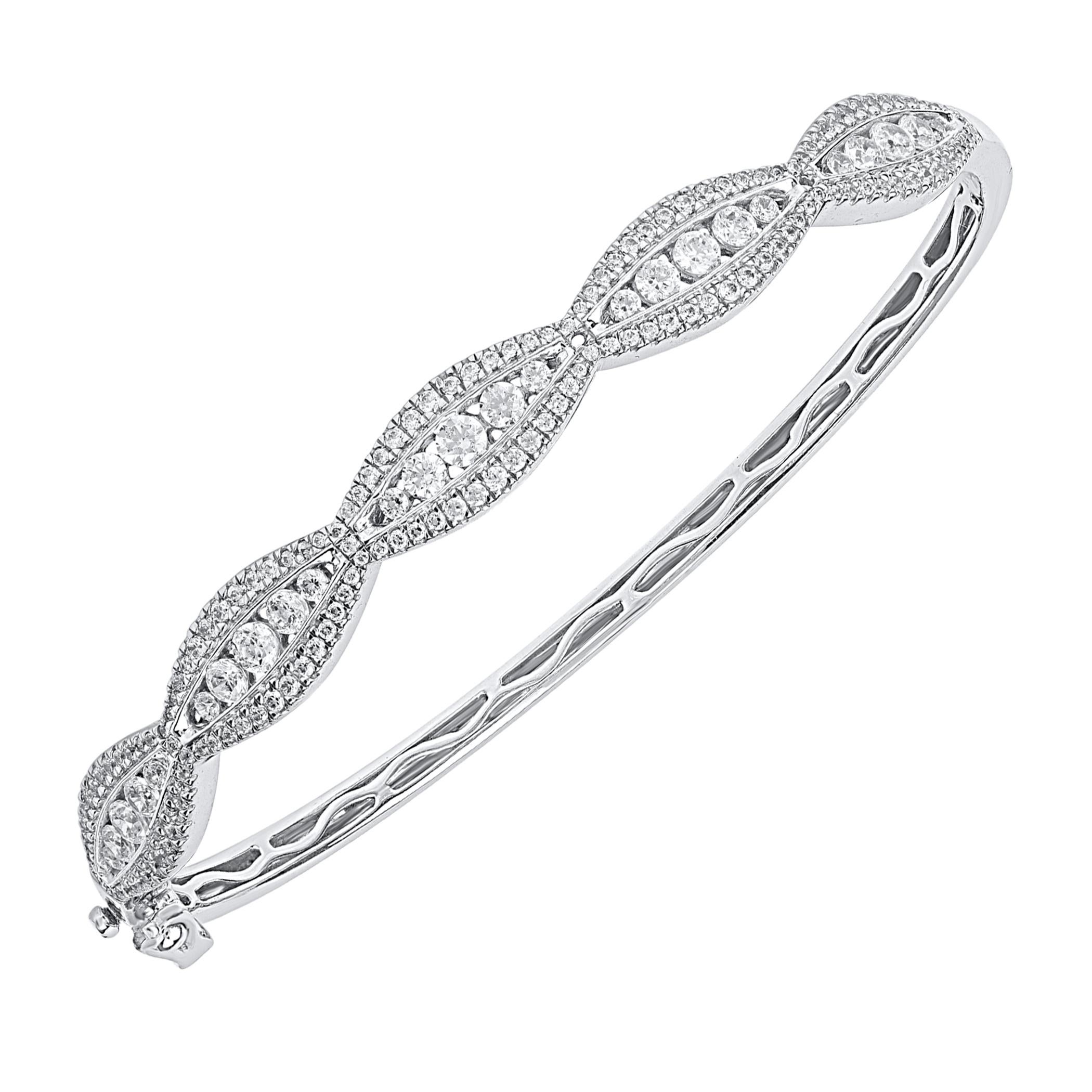 Simple and sparkling, this diamond bangle elevates any attire. Expertly handcrafted by our inhouse experts in 14 karat white gold and studded with 173 round brilliant and single cut natural diamond set in prong and channel setting. The total diamond