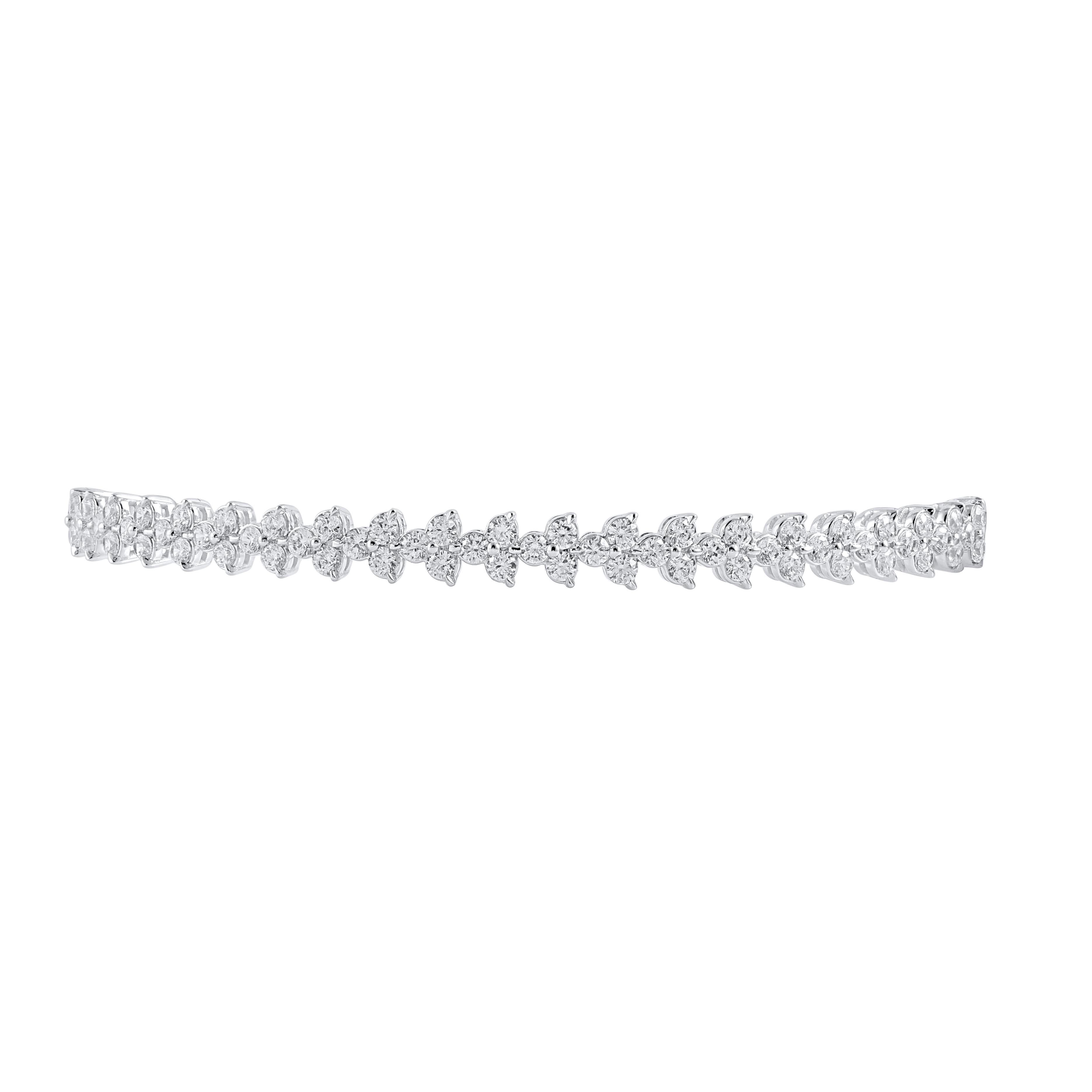 Achieve a most elegant look with the enchanting diamond bangle bracelet. This Shimmering bangle bracelet features 63 natural round brilliant cut diamonds in prong setting and crafted in 18kt white gold. Diamonds are graded H-I color, I-2 clarity. 

